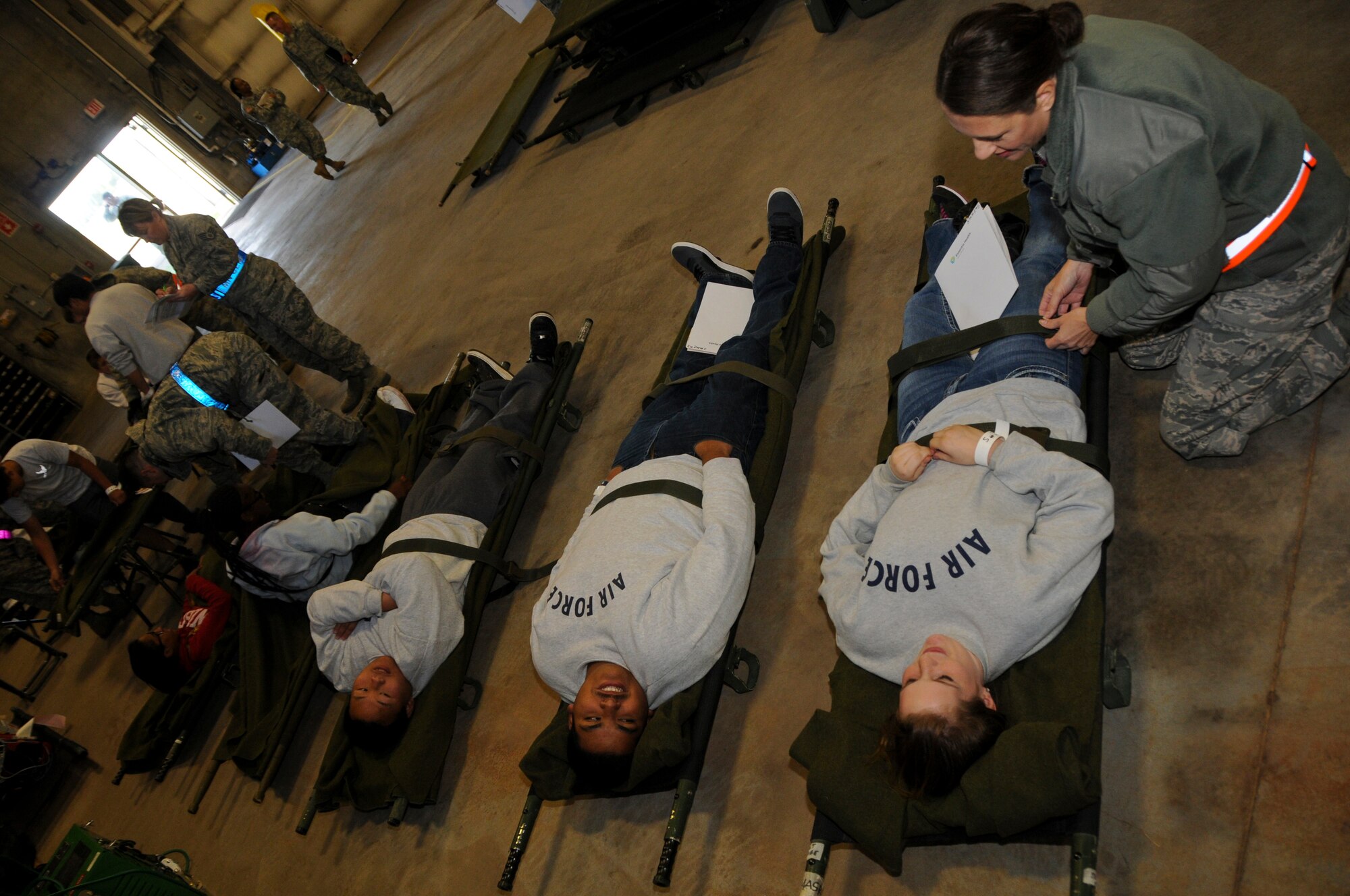 Maj. Michelle Sjobeck, a nurse for the 133rd Airlift Wing, checks on her simulated patients, making sure they are stable and flight ready before they board the C-130’s in Duluth, Minnesota. The exercise simulated a terrorist incident in Duluth that resulted in civilian evacuations to the Twin Cities and Camp Ripley. The training partnered with 14 civilian agencies and utilized many of the 133AW capabilities to help both Airmen and civilians react better when facing disasters. (U.S. Air National Guard photo by Senior Airman Kari Giles.)