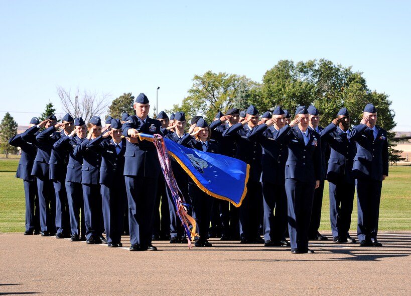 A formation of Team Malmstrom Airmen salute as retreat is sounded during the annual Prisoner of War/Missing in Action Retreat Ceremony on Sept. 20 at Medal of Honor Park. Retreat is played daily on all U.S. military installations to signal the end of the duty day. (U.S. Air Force photo/Staff Sgt. R.J. Biermann)