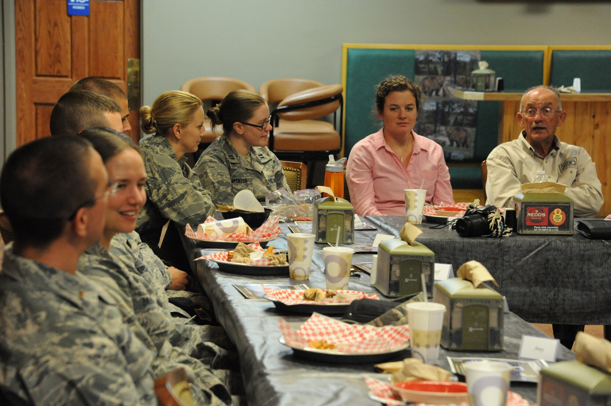 Maj. Gen. (ret.) Edward Mechenbier, (far right) Air Force fighter pilot and Vietnam War prisoner of war, speaks with officers from Malmstrom Air Force Base during lunch at the Aces High Bowling and Entertainment Center. During the lunch, Mechenbier spoke on various topics in relation to the officer’s leadership positions. (U.S. Air Force photo/Airman 1st Class Collin Schmidt)  