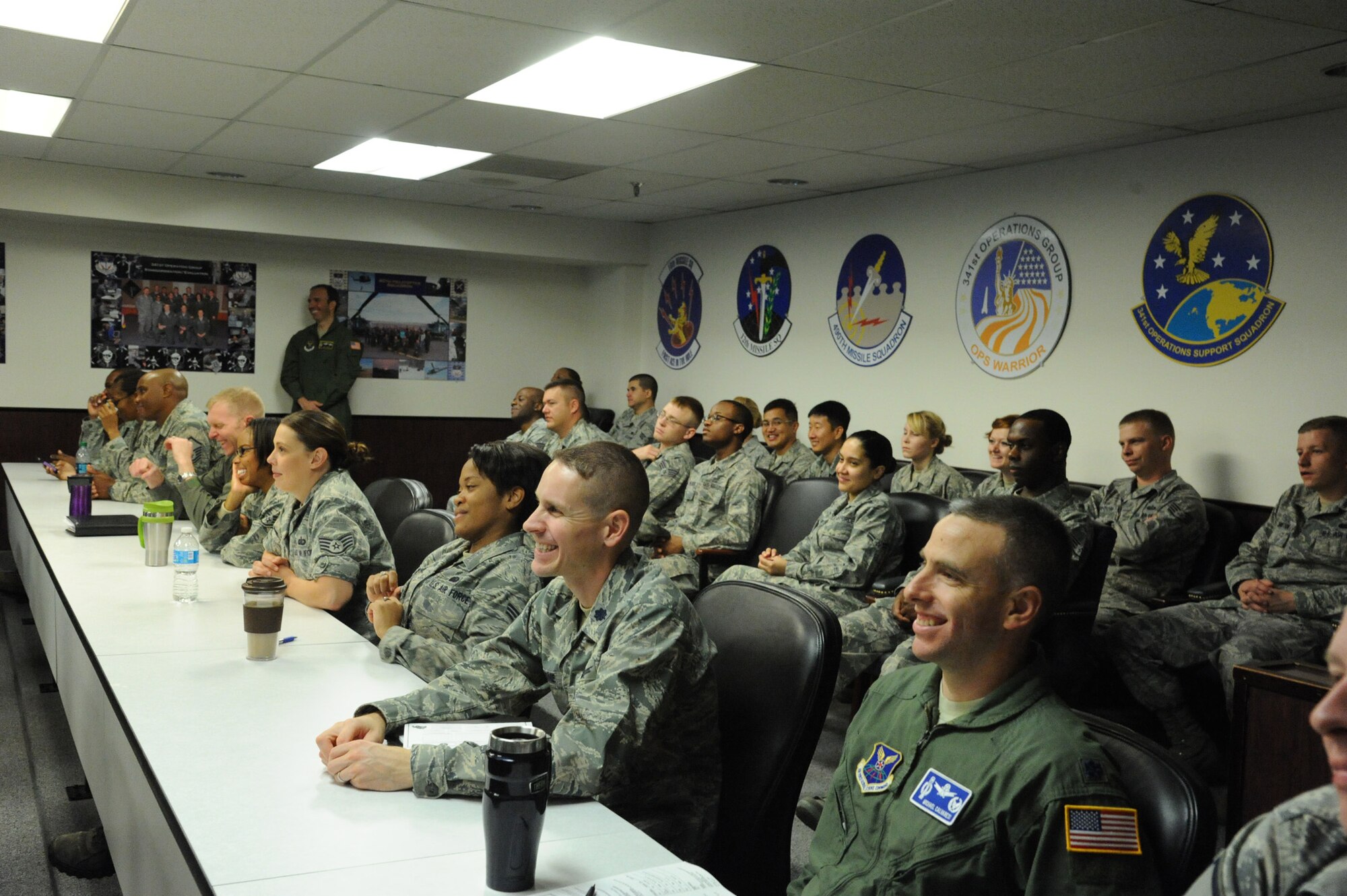 Men and women from the 341st Operations Group listen to Maj. Gen. (ret.) Edward Mechenbier, Air Force fighter pilot and Vietnam prisoner of war, during a pre-departure briefing on Sept 20. Mechenbier toured Malmstrom Air Force base as part of the American300 tour. (U.S. Air Force photo/Airman 1st Class Collin Schmidt)    