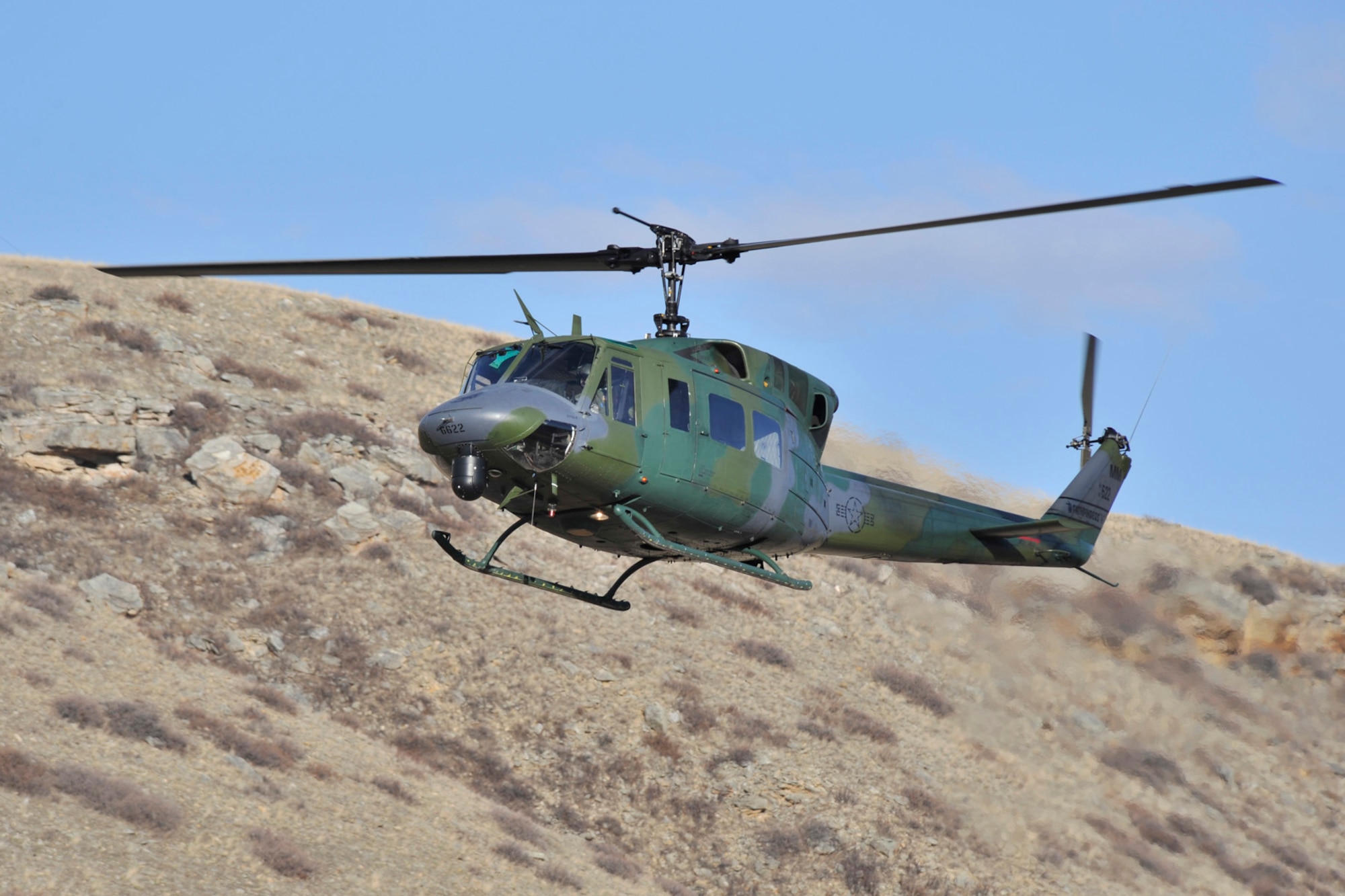 A 40th Helicopter Squadron flight crew flies a UH-1N Huey over Montana’s landscape.  A four-person crew recently completed the unit’s 398th Search and Rescue mission.  (U.S. Air Force photo/John Turner)