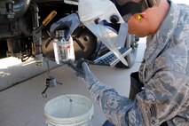 Senior Airman Daniel Hirsch, 302nd Logistics Readiness Squadron fuel technician, takes a sample of JP-8 jet fuel from the filter separator on the R-11 fuel truck to check the fuel for contaminants. (U.S. Air Force photo/Staff Sgt. Nathan Federico)