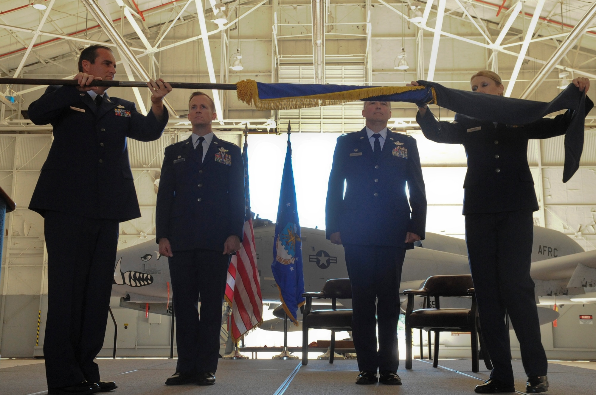 Chief Master Sgt. Cary Johnson, 917th Fighter Group superintendent, and Master Sgt. Kay Lachney, 917th Operations Support Flight First Sergeant, encase the group?s guidon during an inactivation ceremony on Barksdale Air Force Base, La., Sept. 26, 2013. The inactivation is due to the termination of the Continuing Resolution provision and the enacting of the 2013 National Defense Authorization Act, a plan which defines the budget and expenditures of the U.S. Department of Defense. (U.S. Air Force photo/Senior Airman Kristin High)