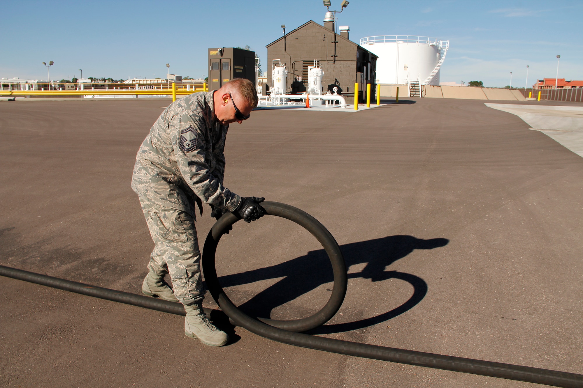 Senior Master Sgt. Sean Foley, 302nd Logistics Readiness Squadron fuels superintendent, physically rolls the 60-foot fuel hose to visually check for wear and tear ensuring the hose meets serviceability standards. (U.S. Air Force photo/Staff Sgt. Nathan Federico)