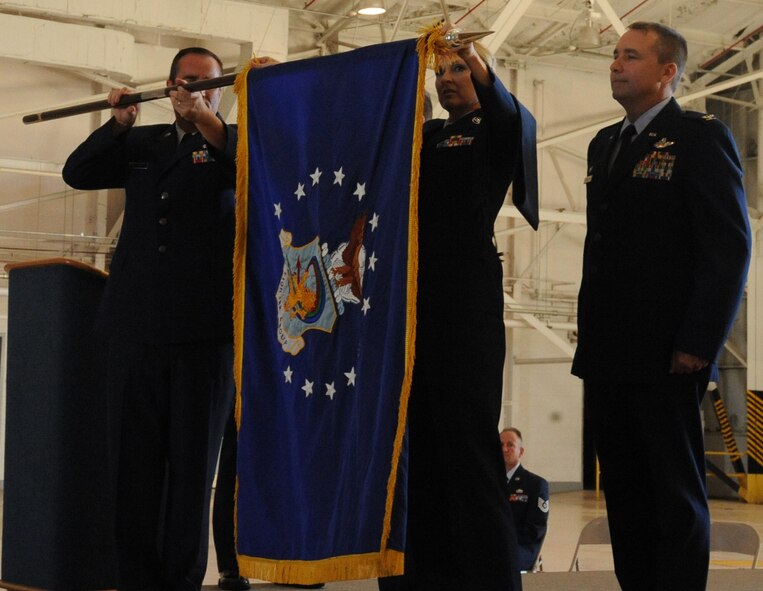 Chief Master Sgt. Cary Johnson, 917th Fighter Group superintendent, and Master Sgt. Kay Lachney, 917th Operations Support Flight First Sergeant, prepare to furl the group's guidon during an inactivation ceremony on Barksdale Air Force Base, La., Sept. 26, 2013. The inactivation is due to the termination of the Continuing Resolution provision and the enacting of the 2013 National Defense Authorization Act, a plan which defines the budget and expenditures of the U.S. Department of Defense. (U.S. Air Force photo/Senior Airman Kristin High)