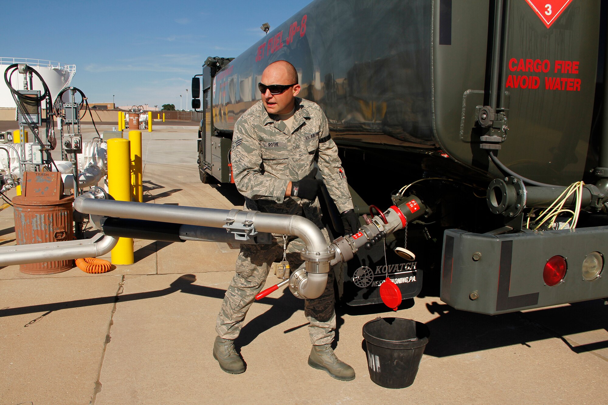Senior Airman Shaun Rothe, 302nd Logistics Readiness Squadron fuels technician, connects a single point nozzle to a 6,000 gallon, R-11 fuel truck’s bottom loader to refuel the tank to full after returning from refueling a C-130 Hercules. (U.S. Air Force photo/Staff Sgt. Nathan Federico)