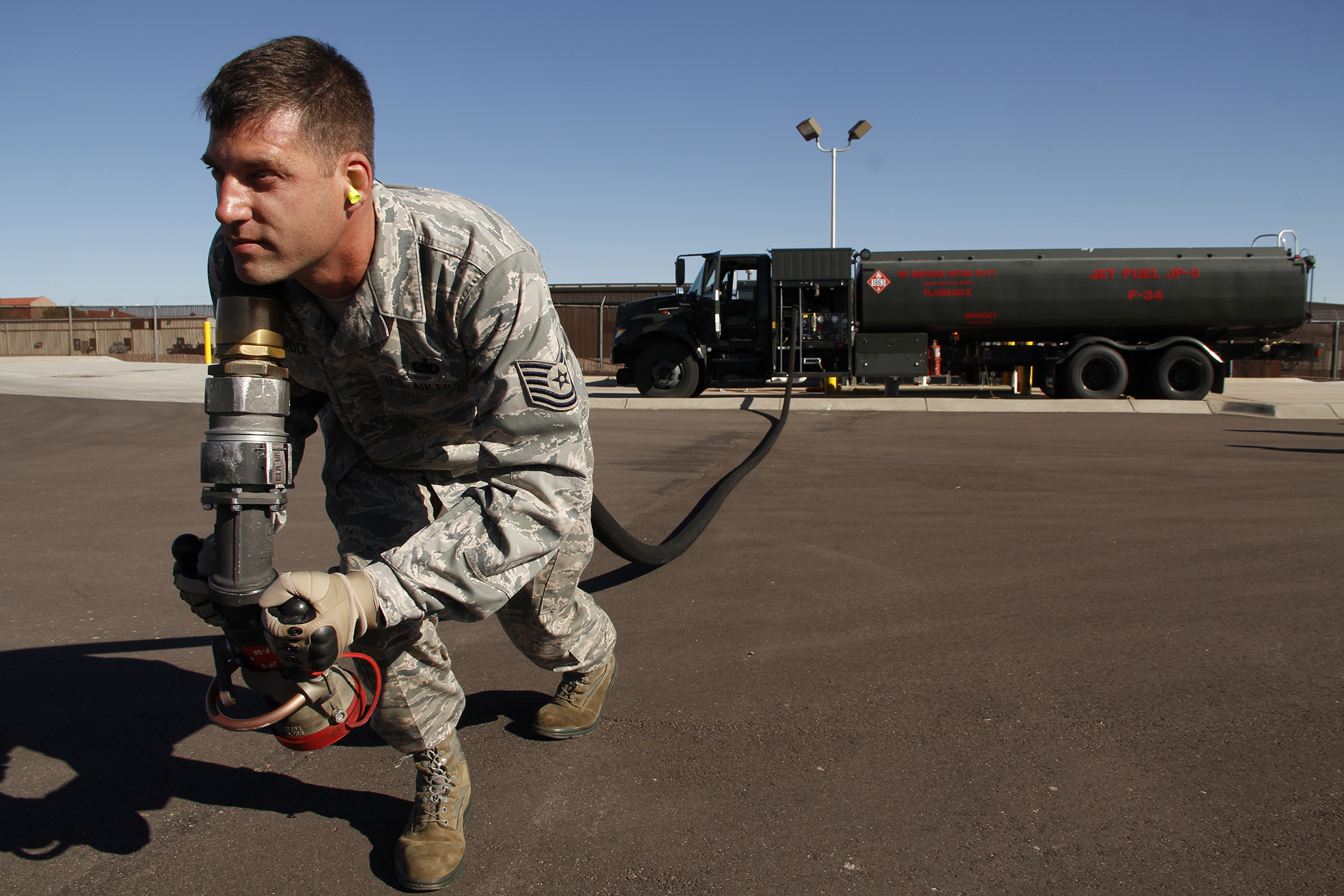 Tech. Sgt. Wittrock runs the fuel hose