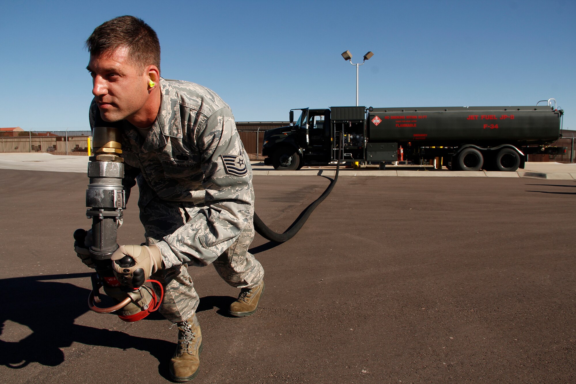 Tech. Sgt. Wade Wittrock, 302nd Logistics Readiness Squadron noncommissioned officer of fuel operations, runs the 60-foot fuel hose out for check point inspection. This is one of many daily inspections fuels does to make sure the R-11 trucks are mechanically and operationally ready to go at a moments notice. (U.S. Air Force photo/Staff Sgt. Nathan Federico)
