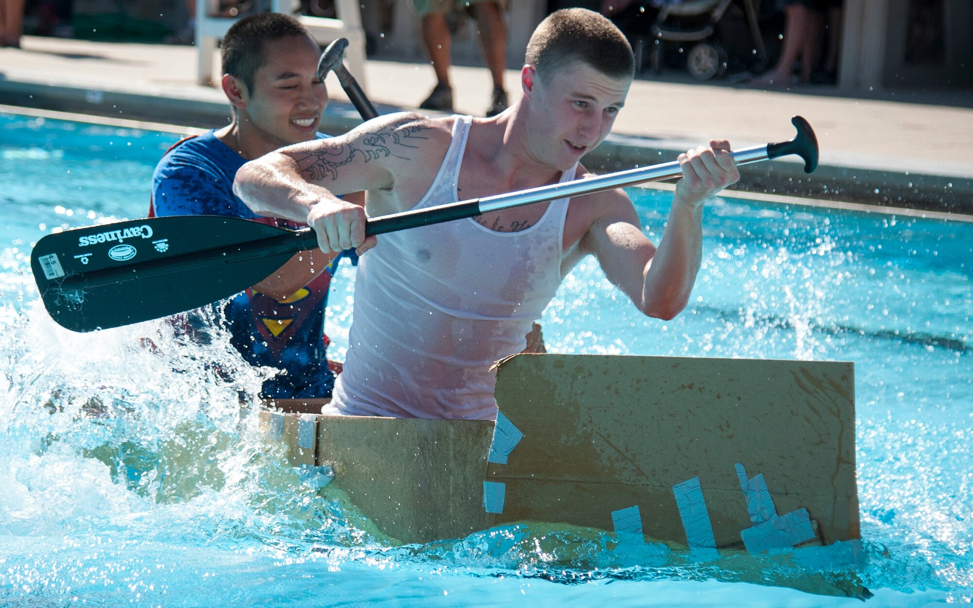 Staff Sgt. Phong Pham, left, and Airman 1st Class Todd Brackenbury, both from the 47th Operations Support Squadron, paddle towards the other side of the pool at Laughlin’s Friendship Pool Sept. 25, 2013. The race was designed to raise morale across the base and to build camaraderie between squadrons and shops. (U.S. Air Force photo/Senior Airman John D. Partlow)
