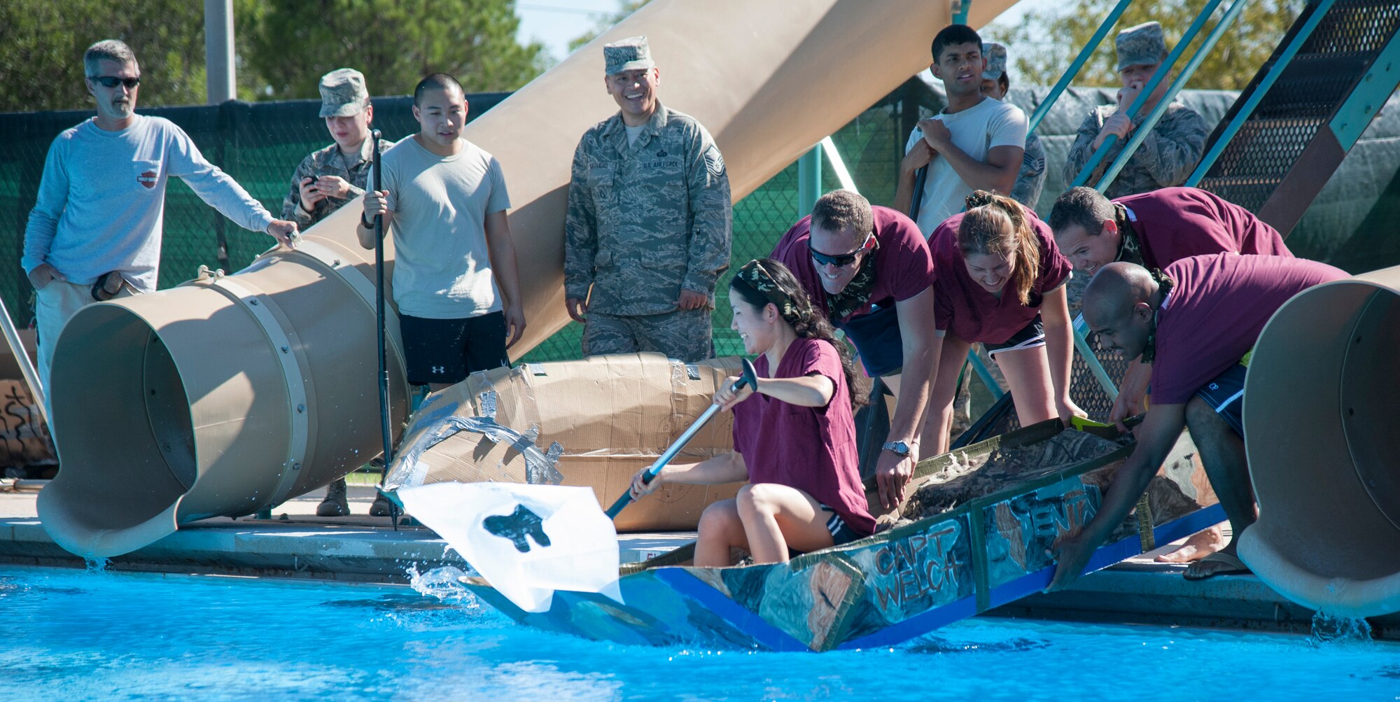 Participants from the cardboard boat race push off to begin at Laughlin’s Friendship Pool Sept. 25, 2013. More than eight four-man teams competed in the race to test their ingenuity and creativeness in racing homemade cardboard boats across the pool. (U.S. Air Force photo/Senior Airman John D. Partlow)