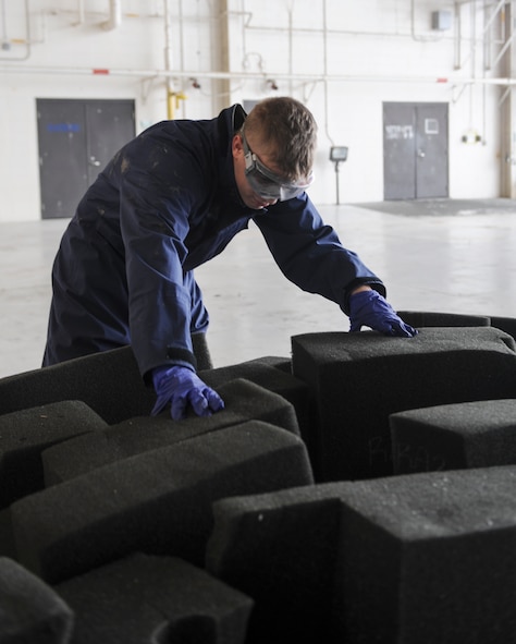 U.S. Air Force Airman 1st Class Zachary Duncan, 23d Component Maintenance Squadron aircraft fuels system apprentice, sorts through foam at Moody Air Force Base, Ga., Sept. 26, 2013. The foam is used for fire suppression on aircraft to protect tanks from small arms fire.  (U.S. Air Force photo by Airman 1st Class Olivia Bumpers/Released)