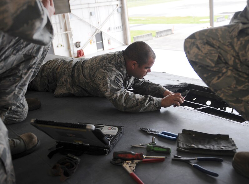 U.S. Air Force Staff Sgt. Jason Roland, 23d Component Maintenance Squadron accessory fight, works on the internal hardware on a HC-130P Combat King at Moody Air Force Base, Ga., Sept. 26, 2013. The 23d CMS aircraft fuel systems repair section maintains internal and external fuel tanks on various aircraft, and fuel and water cell tanks. (U.S. Air Force photo by Airman 1st Class Olivia Bumpers/Released)
