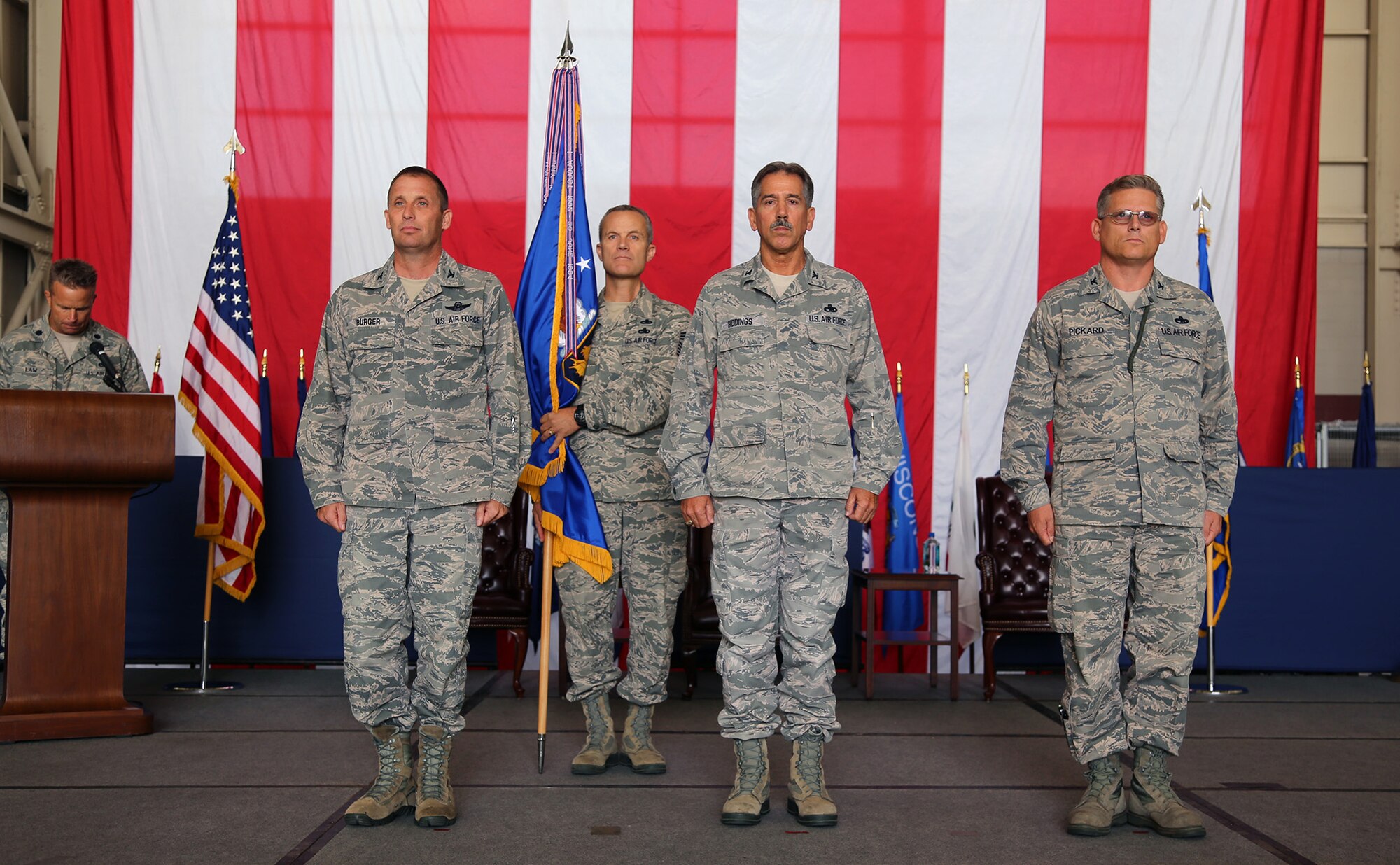 TRAVIS AIR FORCE BASE, Calif. -- Outgoing 349th Maintenance Group commander, Col. Sonny Giddings, center, relinquishes command. Col. Matt Burger, commander of the 349th Air Mobility Wing, left, officiates during ceremony at Travis Air Force Base, Calif., Sept. 22, 2013. A moment later, Col. Jeff Pickard, at right, received the flag and accepted command of the Group. (U.S. Air Force photo/Lt. Col. Robert Couse-Baker)