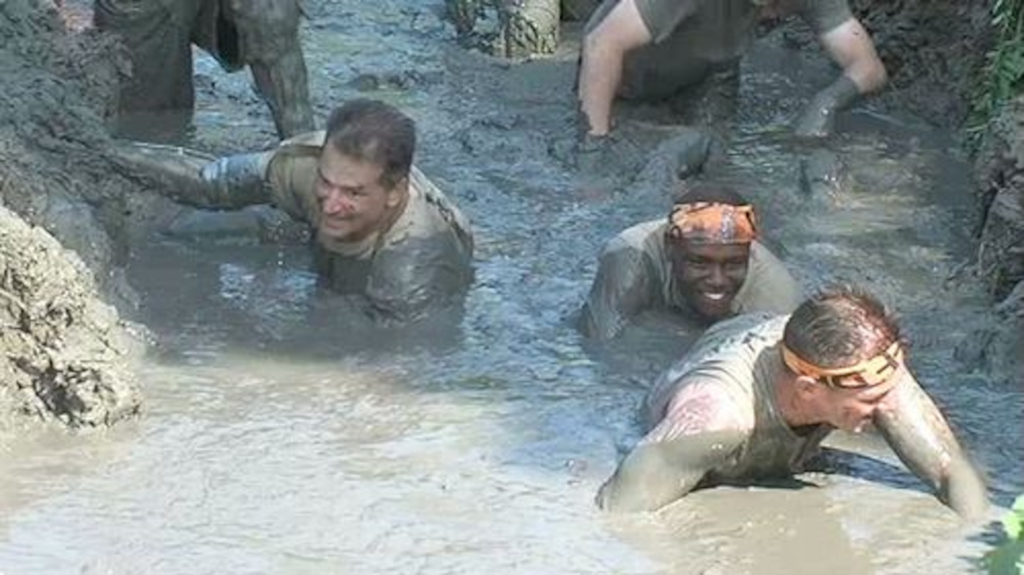 Seven members of the 319th Contracting Flight here took a break from the demands of their daily schedules to take part as a team in the Uff Da Mud Run Sept. 7, 2013, in Grand Forks, N.D. The entire event was about an hour and a half from start to finish, but ended up taking twice that long due to delays with other participants completing some of the tougher obstacles. (Courtesy photo)
