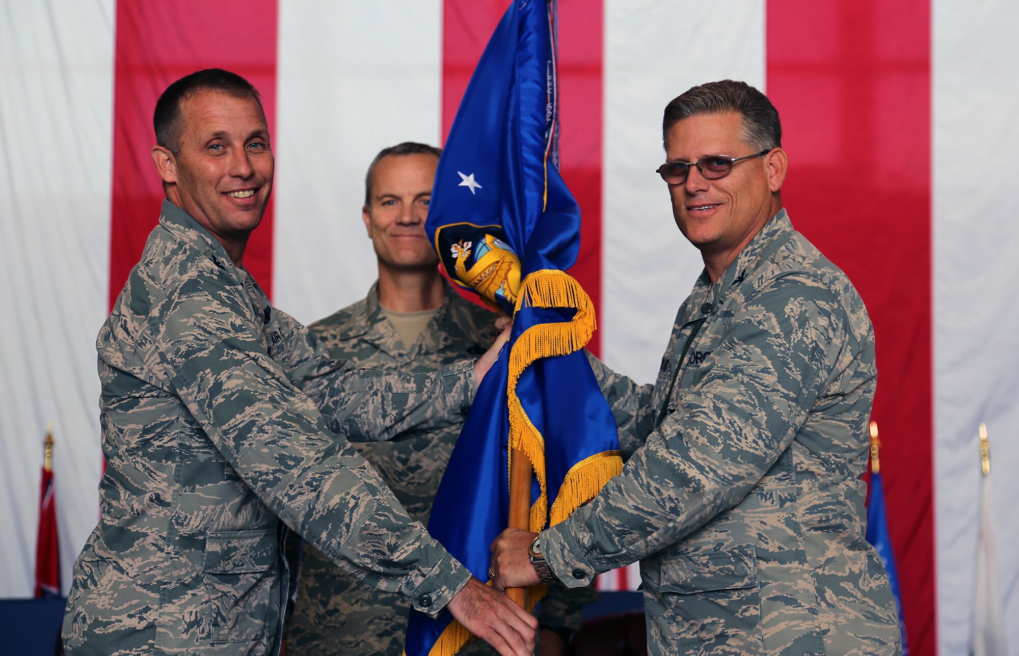 TRAVIS AIR FORCE BASE, Calif. -- Incoming 349th Maintenance Group Commander, Col. Jeff Pickard, receives the Group flag Col. Matt Burger, commander of the 349th Air Mobility Wing, and accepts command of the Group in a ceremony at Travis Air Force Base, Calif., Sept. 22, 2013. Pickard comes to Team Travis after serving as the commander 507th Maintenance Group, Tinker Air Force Base, Okla., since July 2011. A career maintenance officer, the colonel has deployed five times to expeditionary units in Europe, the Pacific and Southwest Asia as a maintenance officer in support of operations Ensuring Freedom and Iraqi Freedom.  (U.S. Air Force photo/Lt. Col. Robert Couse-Baker)