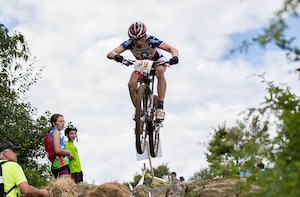 Senior Airman David Flaten executes a "bunny hop” or lifting up of both wheels of the bike off the ground, then exploding upward to clear any obstructions in one’s path, during the 2013 Conseil International Sport Militaire (CISM) cycling competition. The 811th Security Forces Squadron protective service member was selected to represent the United States Armed Forces for the cycling championship event held Sept. 2 to Sept. 6, in Leopoldsburg, Belgium. (Courtesy photo)