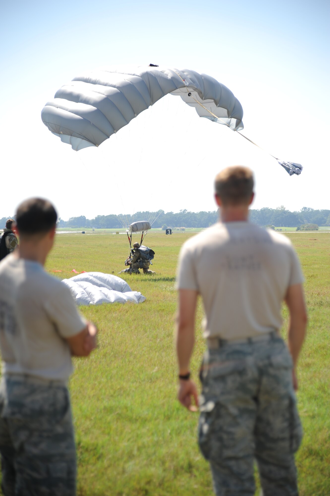 Master Sgt. Wesley Bonin, 403rd Wing, and Col. George Tombe, 81st Training Group commander, land on their target during a tandem jump Sept. 25, 2013, over Keesler Air Force Base, Miss.  Tombe jumped in conjunction with the 334th Training Squadron combat controllers and the 335th Training Squadron special operations weather team for training.  (U.S. Air Force photo by Kemberly Groue)