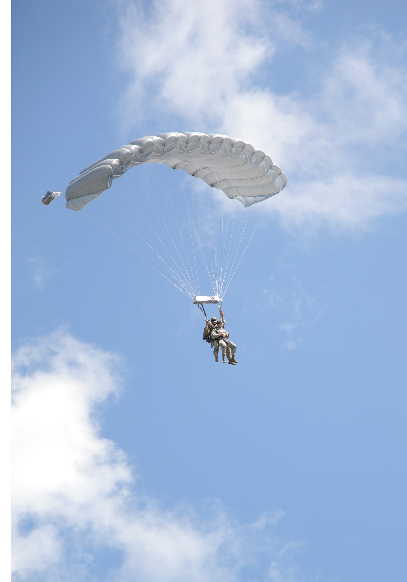 Master Sgt. Wesley Bonin, 403rd Wing, and Col. George Tombe, 81st Training Group commander, parachute toward their target on the flight line during a tandem jump Sept. 25, 2013, at Keesler Air Force Base, Miss.  Tombe jumped in conjunction with the 334th Training Squadron combat controllers and the 335th Training Squadron special operations weather team for training.  (U.S. Air Force photo by Kemberly Groue)