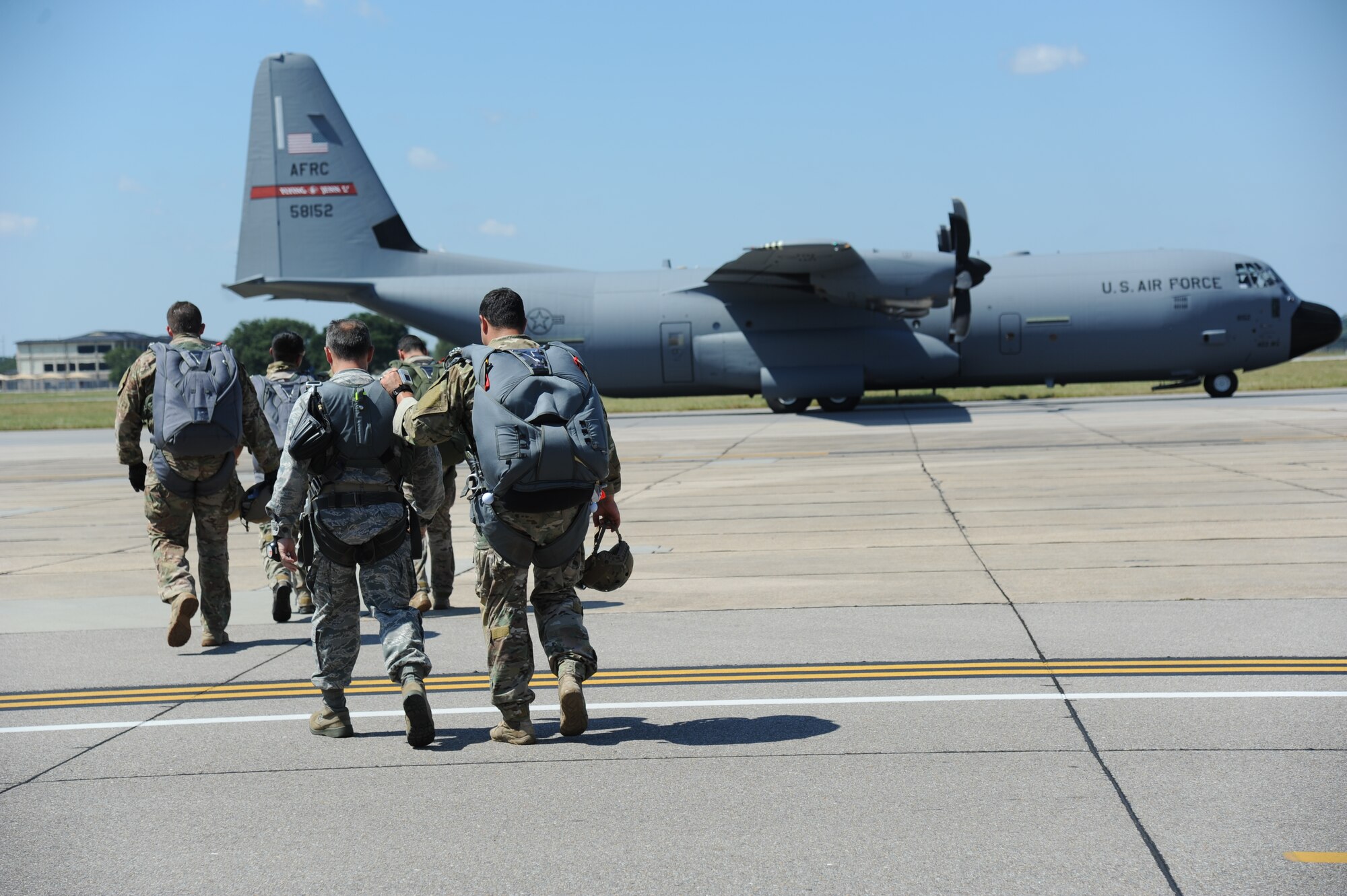 Col. George Tombe, 81st Training Group commander, is escorted by Master Sgt. Wesley Bonin, 403rd Wing, to a U.S. Air Force C-130J to participate in a tandem jump over Keesler Air Force Base, Miss., Sept. 25, 2013.  Tombe jumped in conjunction with the 334th Training Squadron combat controllers and the 335th Training Squadron special operations weather team for training.  (U.S. Air Force photo by Kemberly Groue)
