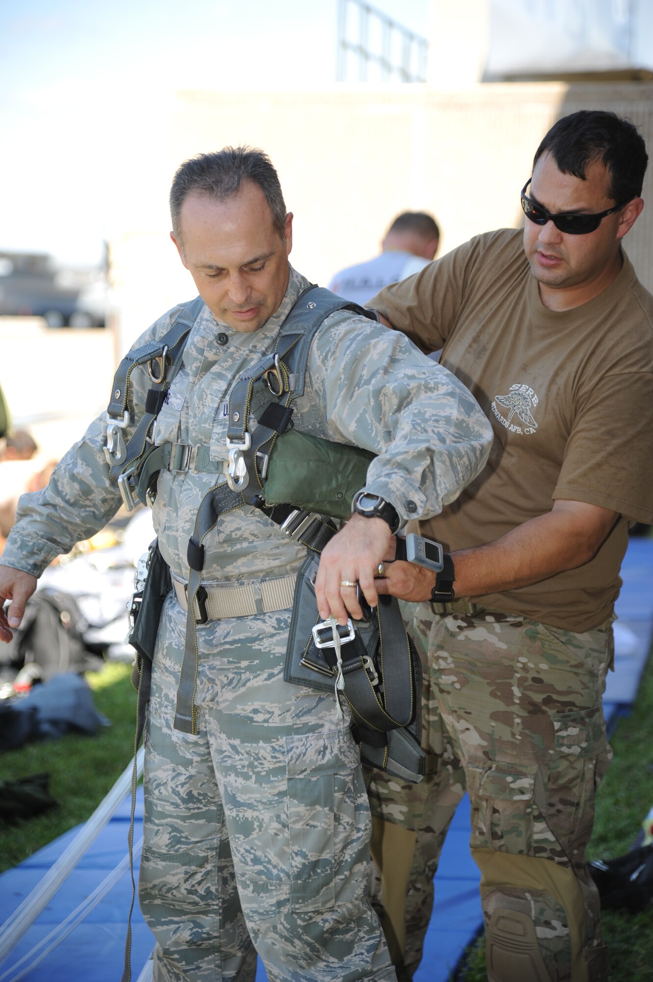 Col. George Tombe, 81st Training Group commander, receives an equipment check by Master Sgt. Wesley Bonin, 403rd Wing, prior to participating in a tandem jump Sept. 25, 2013, over Keesler Air Force Base, Miss.  Tombe jumped in conjunction with the 334th Training Squadron combat controllers and the 335th Training Squadron special operations weather team for training.  (U.S. Air Force photo by Kemberly Groue)