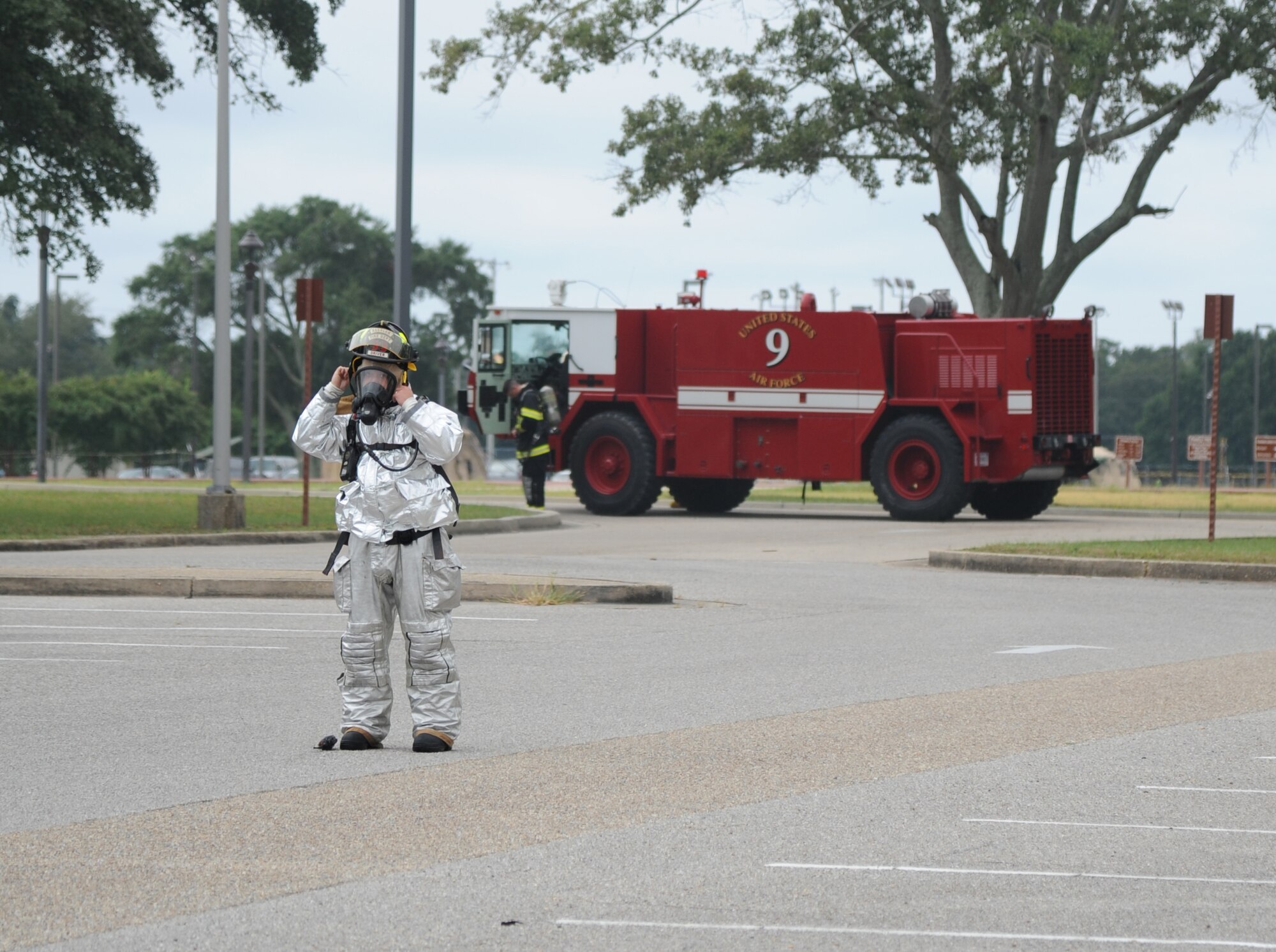Tech. Sgt. Kyle Pourciau, Keesler Fire Department, secures his air mask prior to entering a building during a structure fire exercise Sept. 25, 2013, Keesler Air Force Base, Miss. The scenario consisted of a simulated explosion in a boiler room causing a fire to spread rapidly throughout the building trapping and injuring five role players.  (U.S. Air Force photo by Kemberly Groue)