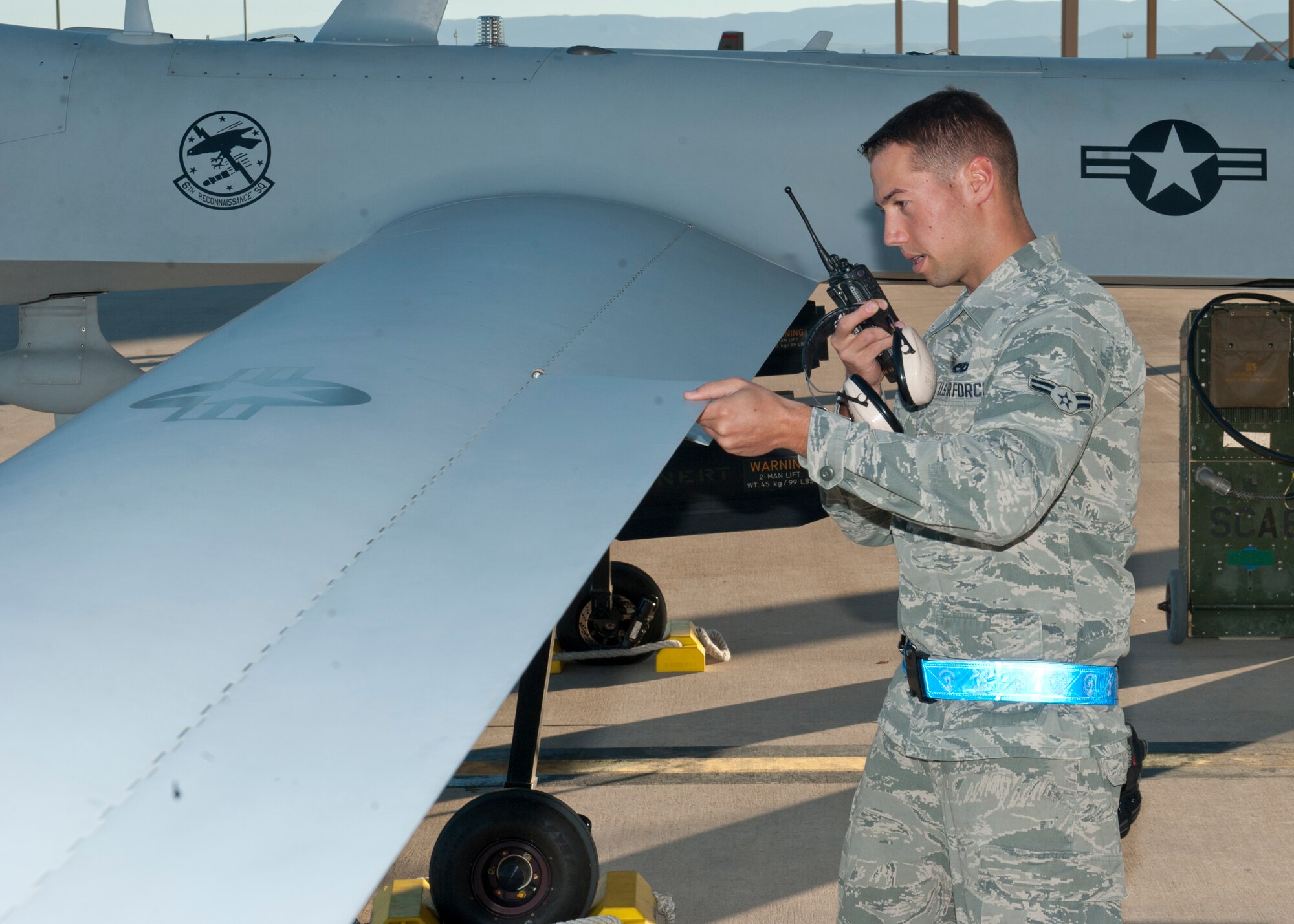 Airman 1st Class Justin Kryla, 849th Aircraft Maintenance Squadron crew chief, performs functionality checks on an MQ-1 Predator at Holloman Air Force Base, N.M., Sept. 25. The Predator’s primary functions are to fulfill reconnaissance and forward observation roles.  In addition to the pilot and sensor operator who control the aircraft from a ground control station, flying an MQ-1 requires a culmination of efforts from various squadrons.  (U.S. Air Force photo by Airman 1st Class Daniel E. Liddicoet/Released)