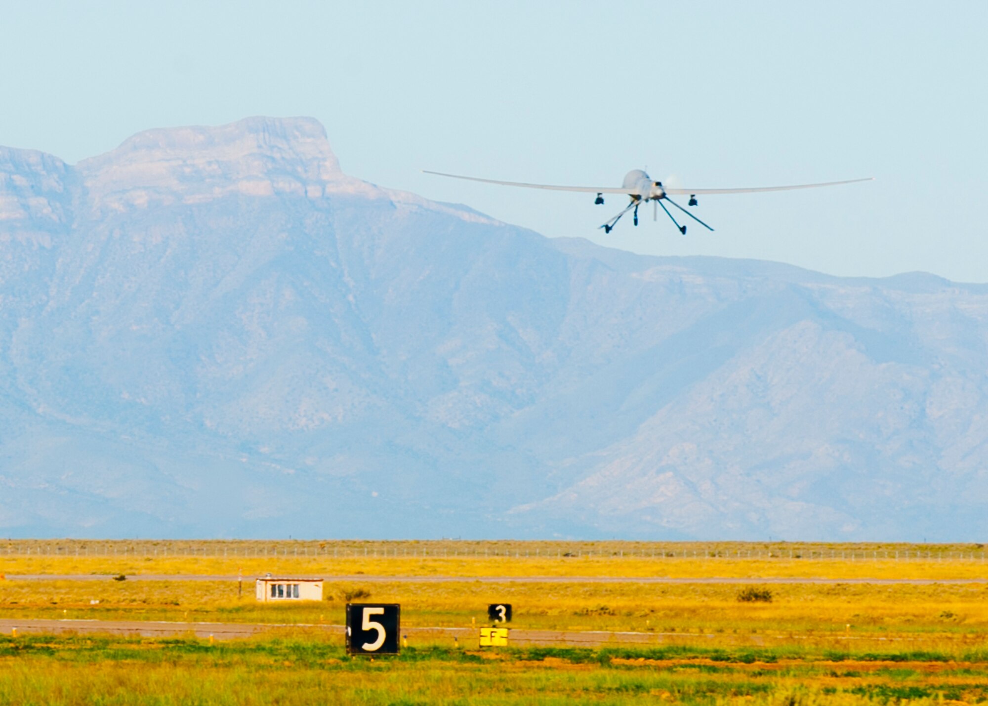 An MQ-1 Predator takes off the runway at Holloman Air Force Base, N.M., Sept. 25. The Predator’s primary functions are to fulfill reconnaissance and forward observation roles.  In addition to the pilot and sensor operator who control the aircraft from a ground control station, flying an MQ-1 requires a culmination of efforts from various squadrons. (U.S. Air Force photo by Airman 1st Class Daniel E. Liddicoet/Released)