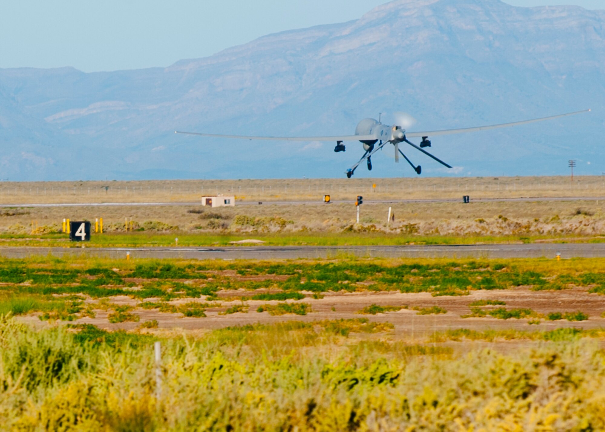 An MQ-1 Predator takes off the runway at Holloman Air Force Base, N.M., Sept. 25. The Predator’s primary functions are to fulfill reconnaissance and forward observation roles.  In addition to the pilot and sensor operator who control the aircraft from a ground control station, flying an MQ-1 requires a culmination of efforts from various squadrons. (U.S. Air Force photo by Airman 1st Daniel E. Liddicoet/Released)