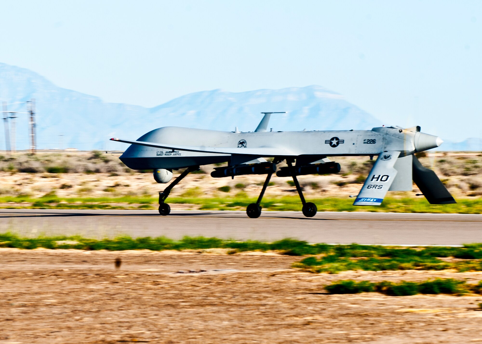 An MQ-1 Predator takes off the runway at Holloman Air Force Base, N.M., Sept. 25. The Predator’s primary functions are to fulfill reconnaissance and forward observation roles.  In addition to the pilot and sensor operator who control the aircraft from a ground control station, flying an MQ-1 requires a culmination of efforts from various squadrons. (U.S. Air Force photo by Airman 1st Class Daniel E. Liddicoet/Released)