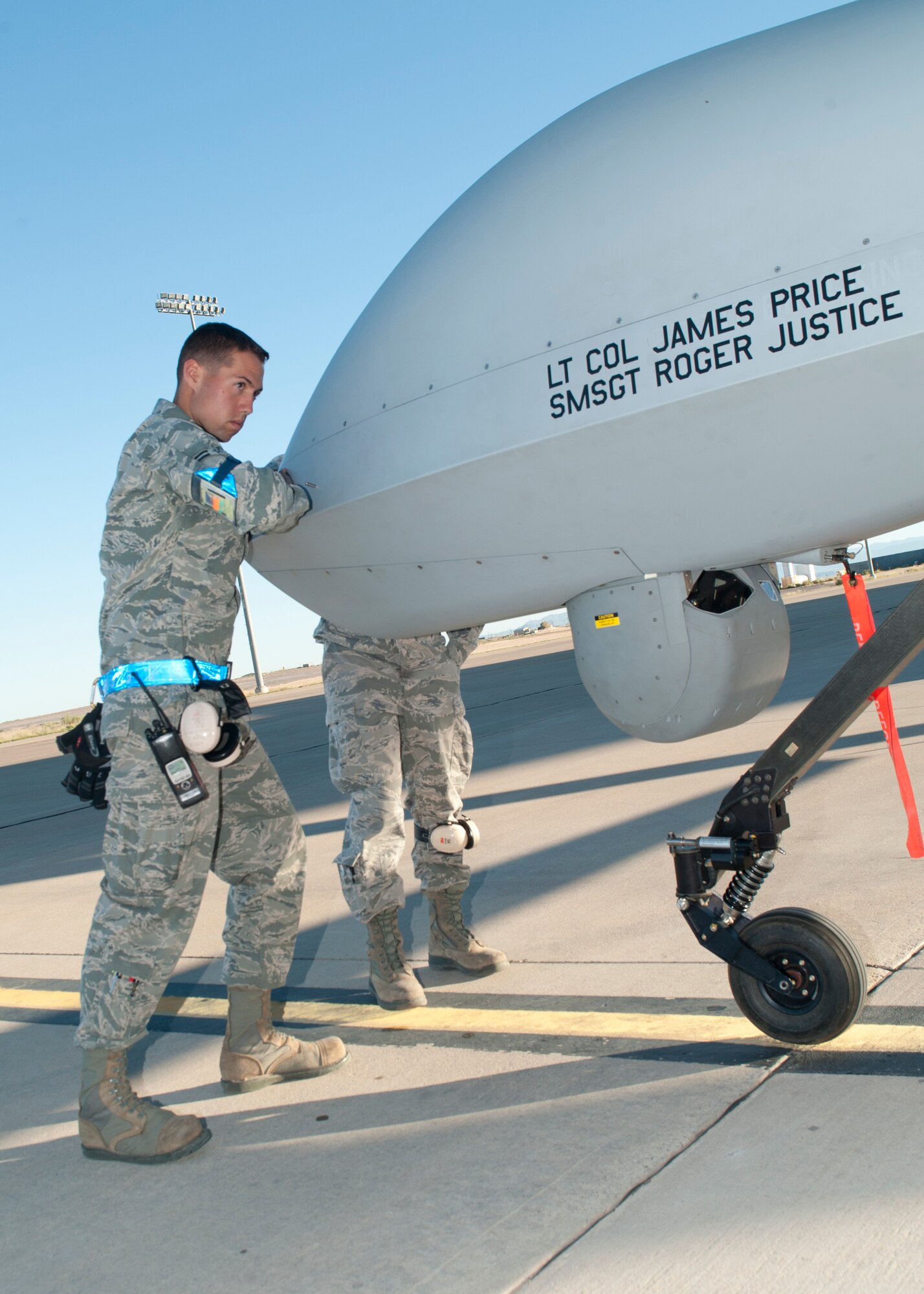 Airman 1st Class Justin Kryla, 849th Aircraft Maintenance Squadron crew chief, performs functionality checks on an MQ-1 Predator at Holloman Air Force Base, N.M., Sept. 25. The Predator’s primary functions are to fulfill reconnaissance and forward observation roles.  In addition to the pilot and sensor operator who control the aircraft from a ground control station, flying an MQ-1 requires a culmination of efforts from various squadrons.  (U.S. Air Force photo by Airman 1st Class Daniel E. Liddicoet/Released)