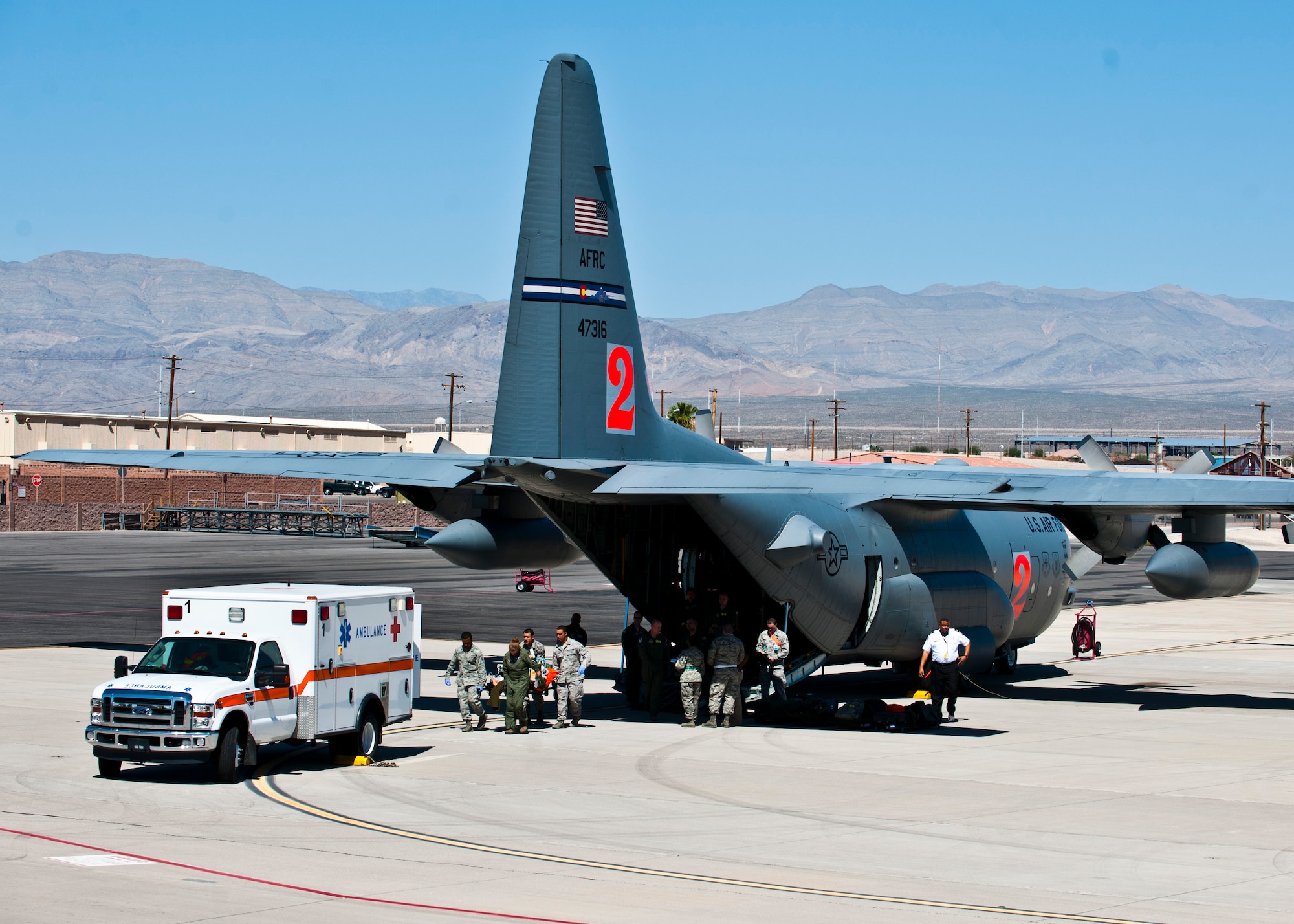 Simulated victims are carried off a C-130 Hercules Sept. 19, 2013, during Operation Swift Savior, a National Disaster medical System exercise, at Nellis Air Force Base, Nev. The C-130 Hercules from the 302nd Airlift Wing, Peterson AFB, Colo., brought in mannequins to simulate patients being transported from a VA hospital in Arizona to Southern Nevada. (U.S. Air Force photo/Senior Airman Brett Clashman)