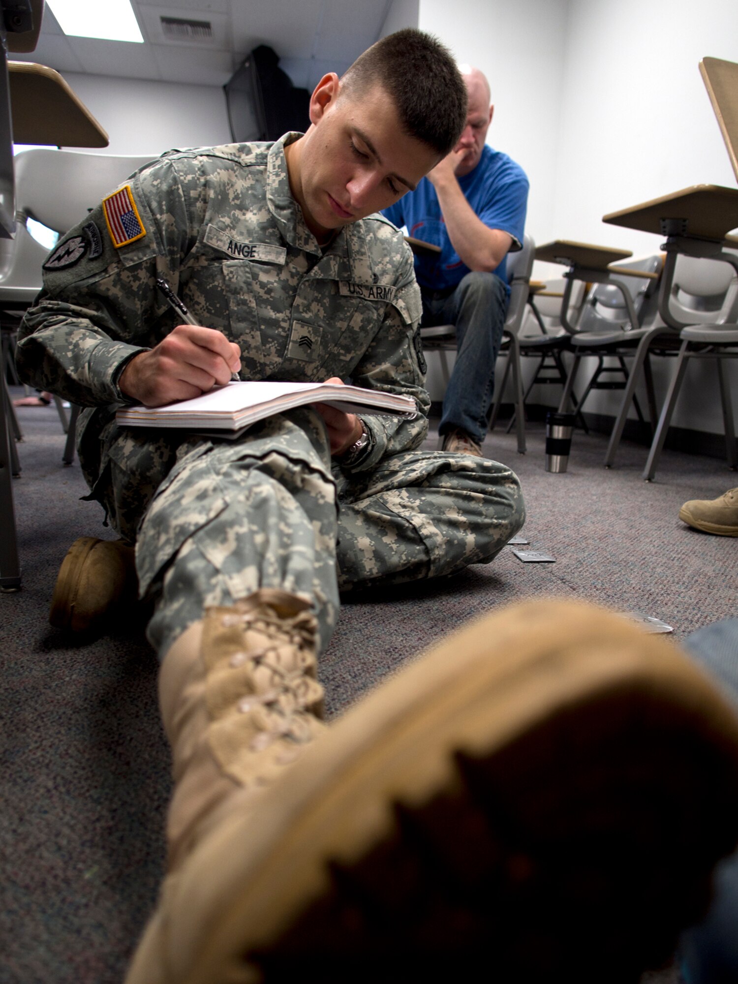 Sgt. Brandt Ange, an Army ROTC cadet at the University of Alaska Anchorage and native of Kennesaw GA., writes notes during ROTC class. Ange is an Afghanistan veteran who deployed with the 425th Brigade Special Troops Battalion. (U.S. Air Force photo/David Bedard)