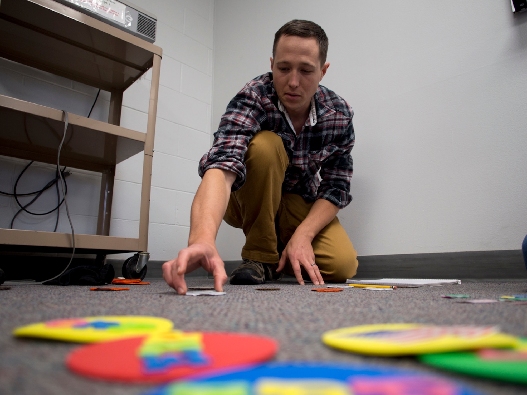 Sgt. 1st Class Jamieson Barnes, an Army ROTC cadet at the University of Alaska Anchorage and native of Homesville, Ohio, builds a terrain model during ROTC class. Barnes completed two years of study, making him eligible for the Green to Gold Active Duty Option Program, allowing him to earn his commission in two years. (U.S. Air Force photo/David Bedard)
