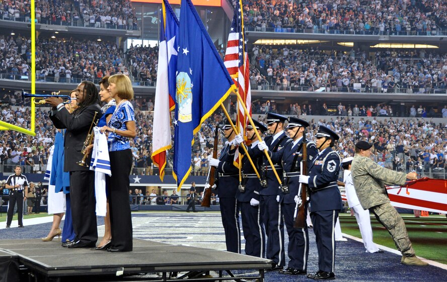 The 301st Fighter Wing Color Guard present the colors during this year's Dallas Cowboys season opener against the New York Giants. More than 200 local military from the Air Force, Navy, Marines and Army stood side by side on centerfield honoring the American Flag. Most of the participants are stationed at the Naval Air Station Fort Worth Joint Reserve Base, Texas. (U.S. Air Force photo/MSgt Joshua Woods)