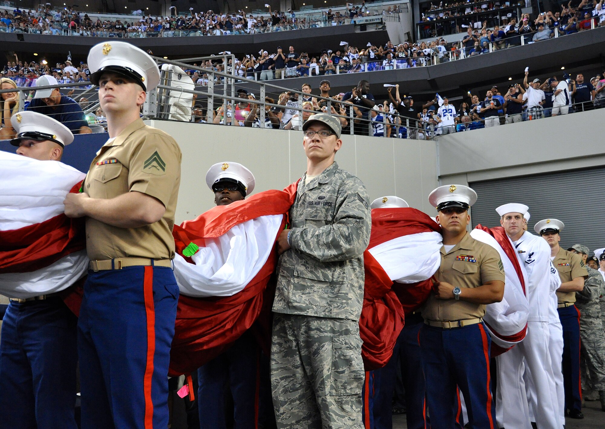 During this year's Dallas Cowboys season opener against the New York Giants, 200 local military from the Air Force, Navy, Marines and Army stood side by side on centerfield honoring the American Flag. Most of the participants are stationed at the Naval Air Station Fort Worth Joint Reserve Base, Texas. (U.S. Air Force photo/MSgt Joshua Woods)