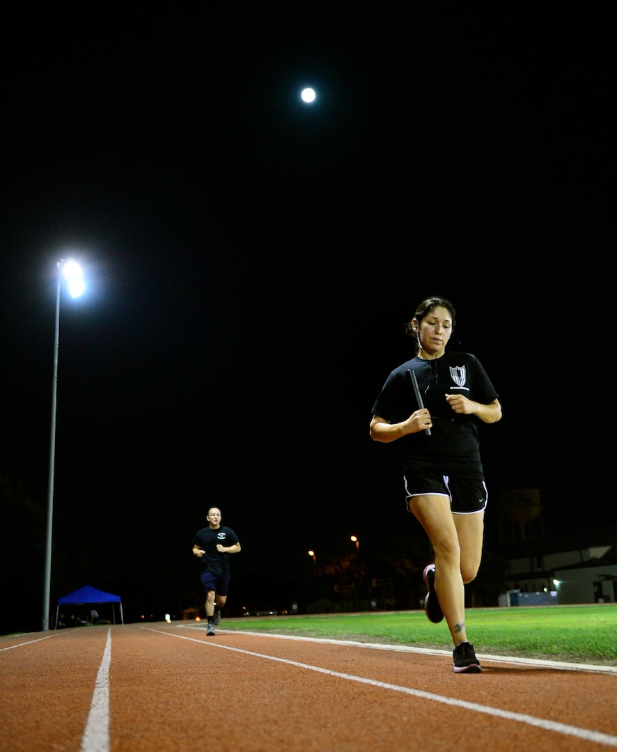 Stephanie Escobedo, 59th Medical Wing contractor, runs in honor of the prisoners of war and those still missing in action, Sept. 19, 2013. Airmen assigned to Joint Base San Antonio-Lackland, Texas, participated in a 24-hour rotation run in honor of those service members who were POW's and those still MIA. (U.S. Air Force photo by Staff Sgt. Vernon Young Jr./Released)