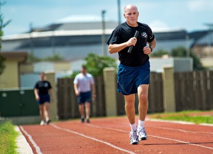 Col. Steve Taylor, Dental Support Squadron commander, runs his leg of the Prisoner of War/Missing in Action relay race September 20, at Joint Base San Antonio-Lackland. The Airman run a 24 hr. relay race which culminates in a baton handoff to awaiting families members of past and present POW/MIA's. (U.S. Air Force photo by Benjamin Faske/released)