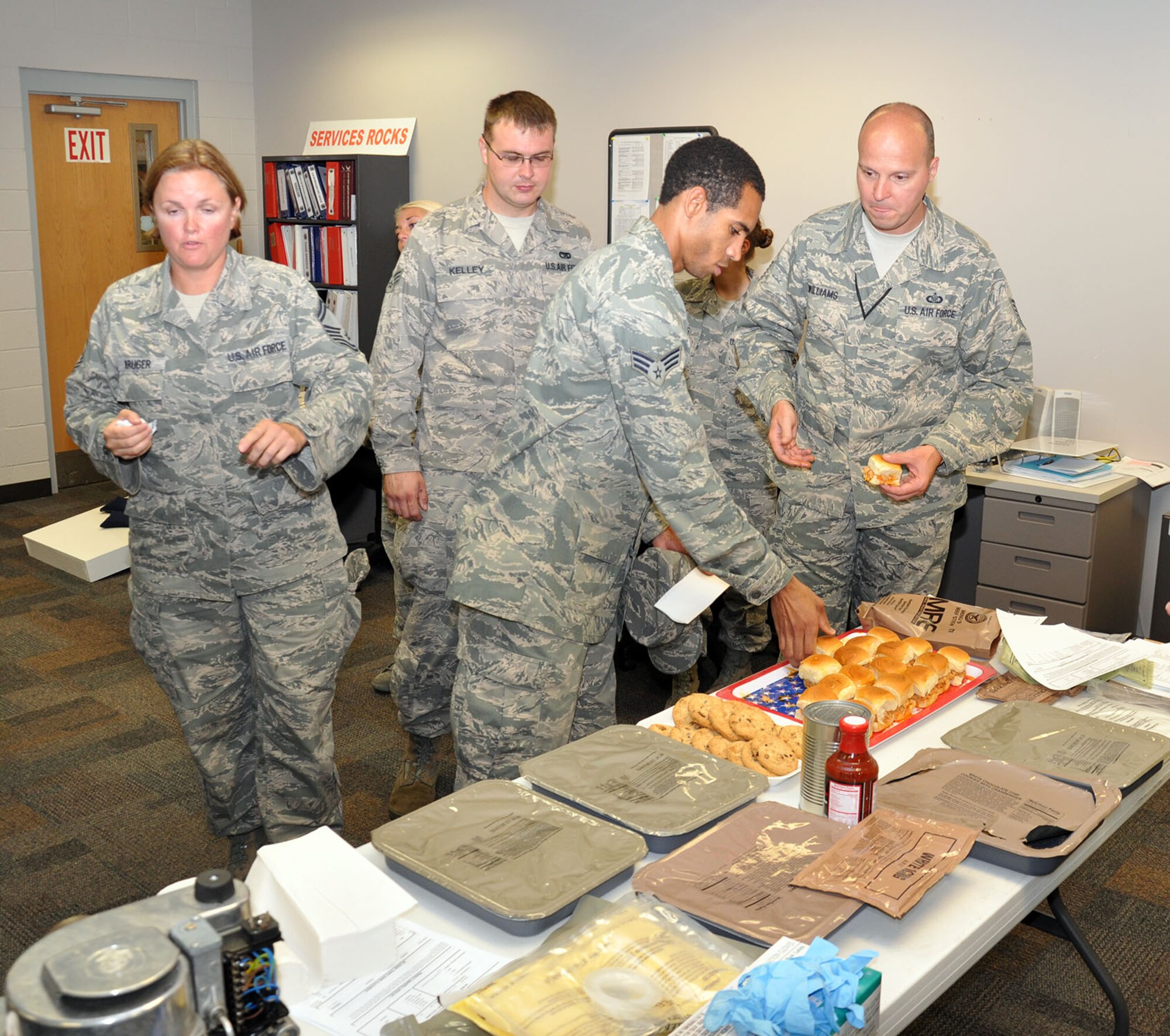 WRIGHT-PATTERSON AIR FORCE BASE, Ohio – 445th Airlift Wing job swap participants sample buffalo chicken sliders and cookies prepared by the 445th Services Sustainment Flight using field operating food supplies after learning the various roles of the flight during the Sept. 8 445th FSS job swap. (U.S. Air Force photo/Capt. Demetrius Smith)