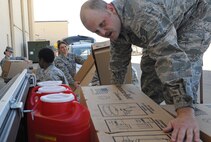 Staff Sgt. Blair Morin, 5th Medical Operations Squadron primary health element leader, loads critical supplies used in support of the 5th Medical Group's Point of Distribution exercise at Dock 9, Sept. 19-20. During this exercise, 5th MDG personnel demonstrated their ability to issue emergency medical supplies and medication to the active duty population in a timely and precise manner. (U.S. Air Force photo/Senior Airman Jose L. Hernandez)