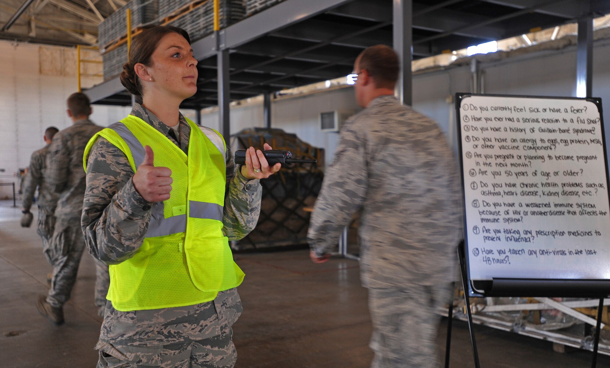 Staff Sgt. Tara Crook, 5th Medical Operations Squadron force health management noncommissioned officer in charge, ensures safe and orderly distribution of the flu mist to Airmen as part of the 5th Medical Group’s Point of Distribution exercise at Dock 9, Sept. 19-20. The POD exercise evaluated the 5th MDG's ability to distribute emergency medical supplies to the active duty population. The 5th MDG in conjunction with the 5th Logistics Readiness Squadron and 5th Security Force Squadron was able to precisely load, transport, vaccinate and return more than 2,000 Airmen during the POD exercise in an average time of 17 minutes per person. (U.S. Air Force photo/Senior Airman Jose L. Hernandez)