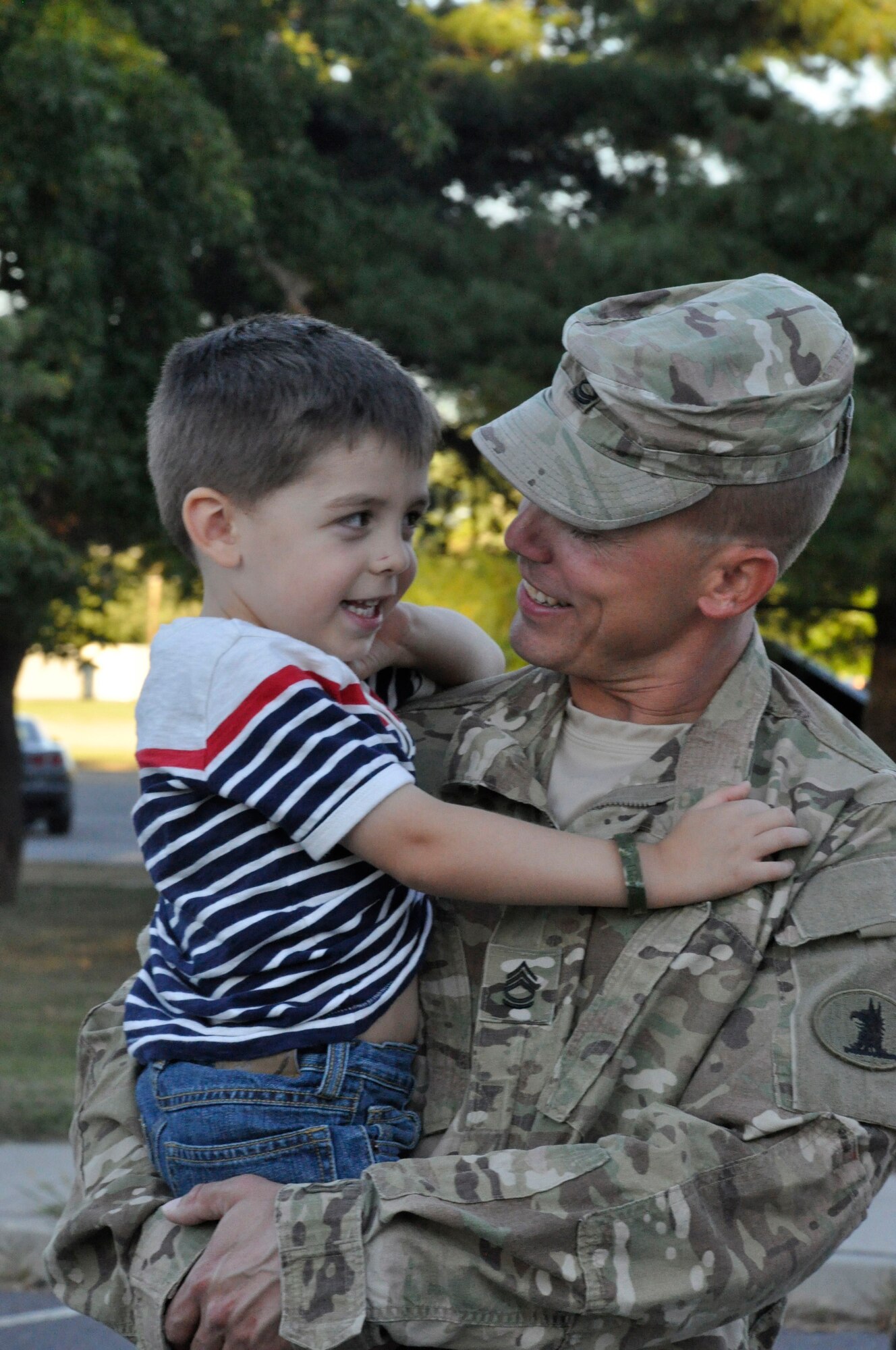 Sgt. 1st Class Bruce Ashby and his son, Landon, share a smile, in person, upon his return from a nine-month deployment to Afghanistan with the 153rd Military Police Company. (U.S. Army photo by Staff Sgt. Wendy McDougall/Released)