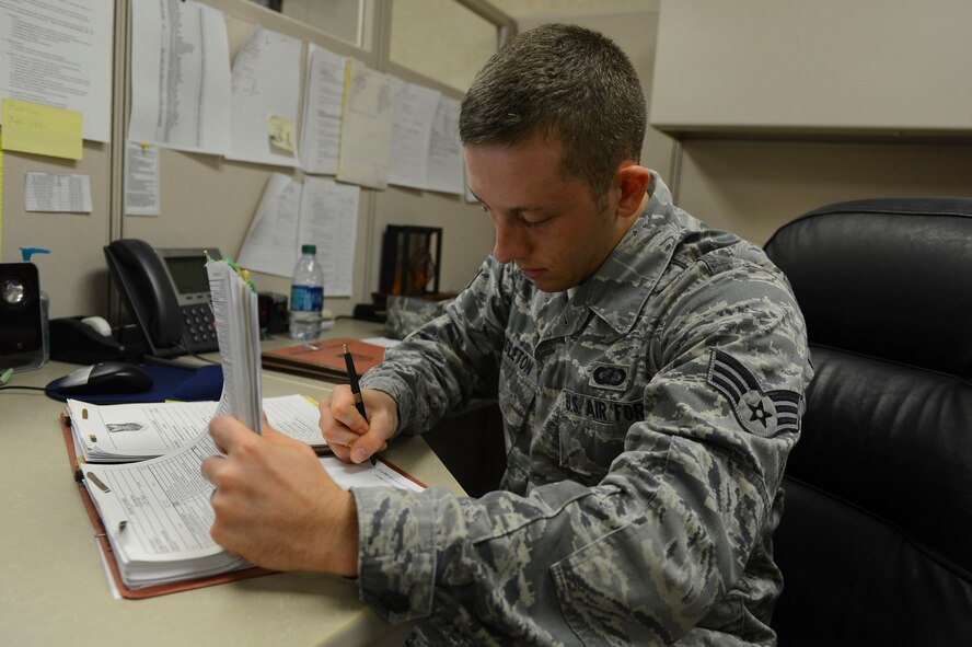 Senior Airman Kent Pendleton, 2nd Contracting Squadron contracting specialist, makes corrections to a contract on Barksdale Air Force Base, La., Sept. 20, 2013. Before a contract can be approved by a contracting officer, it must be reviewed by other contracting specialist to ensure all the information is correct and that no items are missing. (U.S. Air Force photo\Senior Airman Micaiah Anthony)