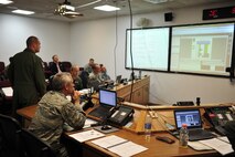 Col. Robert J. Vercher, 91st Missile Wing commander, monitors the progress of a Simulated Electronic Launch - Minuteman, or SELM, operational test, here, Sept. 17-18. A SELM is the most complete test of the operational capability of the Intercontinental Ballistic Missile. No actual missiles are launched. (U.S. Air Force photo/Airman 1st Class Kristoffer Kaubisch )