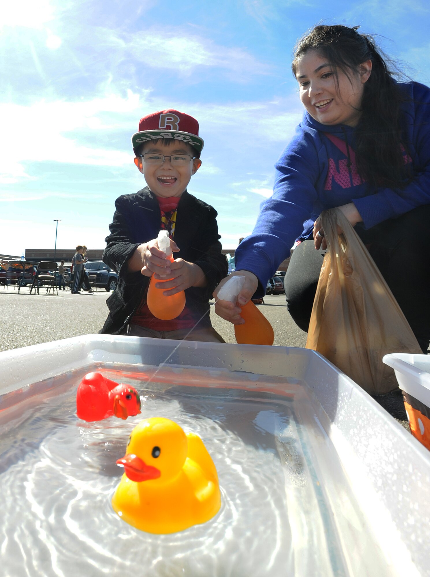 Andrea Soto-Hernandez, wife of Staff Sgt. Rufino Soto-Garcia, and her son Emiliano play a duck race game at this year’s 15th Annual Fall Festival, Sept. 21. Hosted by the 741st Missile Squadron Gravel Hauler’s Association, the event is put together in part as a fundraiser, as well as a way to bring Airmen and their families together in a day of family activities. (U.S. Air Force photo/Senior Airman Jose L. Hernandez)