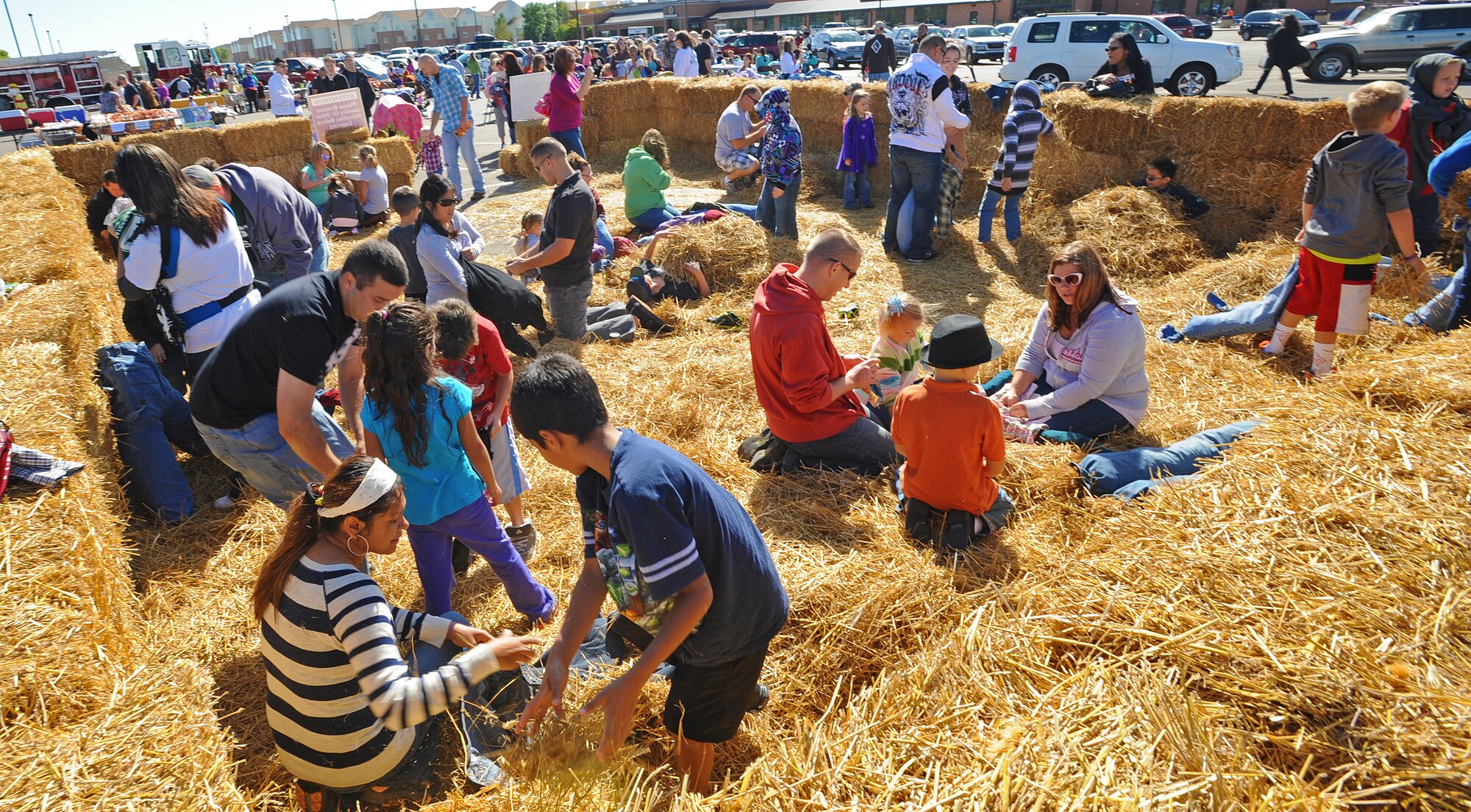 Airmen and their families use hay to make scarecrows during the 15th Annual Fall Festival, Sept. 21. Hosted by the 741st Missile Squadron Gravel Hauler’s Association, the event is put together in part as a fundraiser, as well as a way to bring Airmen and their families together in a day of family activities. (U.S. Air Force photo/Senior Airman Jose L. Hernandez)