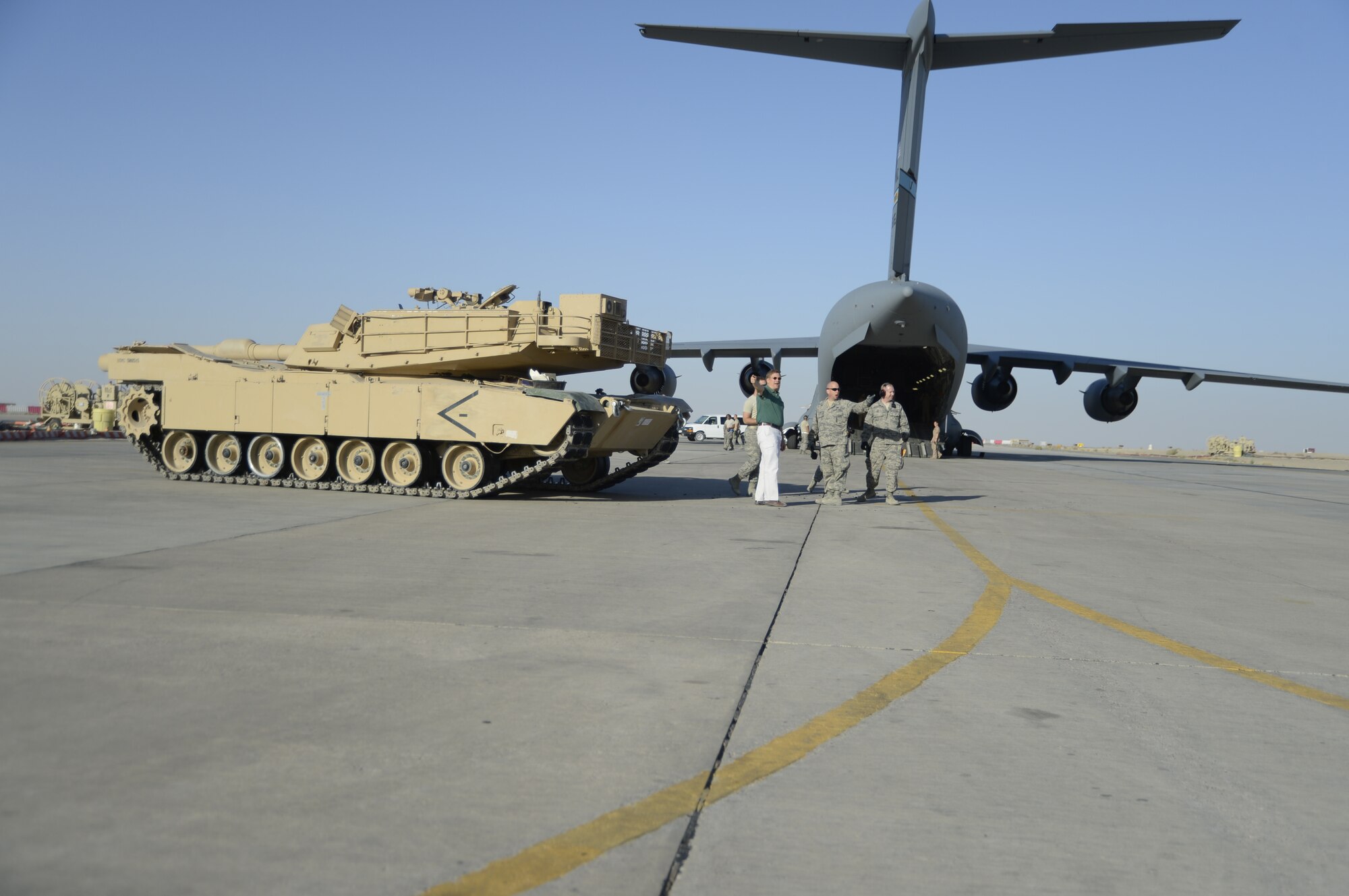 Members of the 386th Air Expeditionary Wing monitor the offload of a M1 Abrams tank from a C-17 Globemaster III here, Sept. 26, 2013.  Ramp personnel at the 386th Air Expeditionary Wing on average handle more than 3,000 tons of cargo each month.  (U.S. Air Force photo by Master Sgt. Christopher A. Campbell)