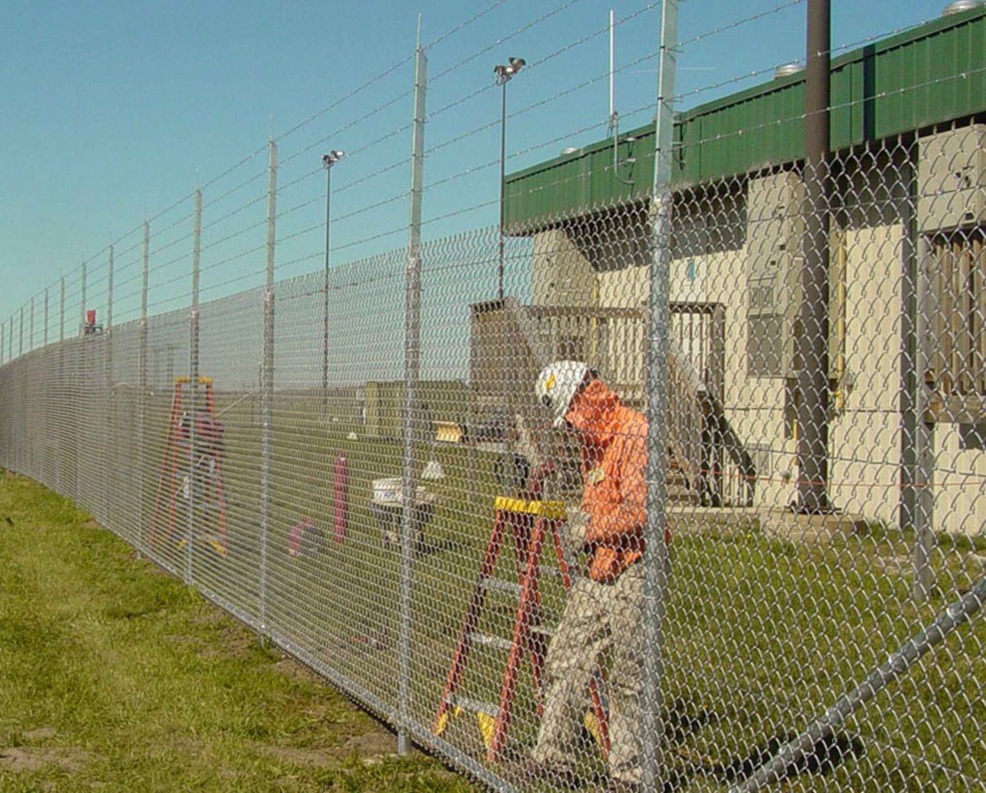 A program office here is ensuring U.S. Air Force critical assets have increased protection with the recent completion of two projects.
Last month, the Force Protection Division concluded government acceptance testing on Intrusion Detection Systems at Sioux City Air National Guard Base, Iowa, and Toledo Air National Guard Base, Ohio. 
“The purpose of these systems is to augment the role of security forces personnel on the base to ensure priority resources are protected,” said Jason Hamblen, project lead. “The IDS automatically detects an intruder approaching a restricted area boundary and notifies security forces personnel at the Base Defense Operations Center with an alarm and video so they can have a visual of what is happening.” 
The Security Forces Squadron Commander at Sioux City ANGB, Maj. Brandon East, also emphasized the importance of the IDS. 
“Our IDS has increased our flightline security tenfold,” he said. “The high-definition cameras provide crystal clear images of the situation enabling the BDOC controller to have a much better understanding of what is going on. The sensor system provides immediate information on the perimeter breach with the cameras panning to that specific location; reaction time has been cut tremendously.” 
The electronic security systems consist of items such as sensors and assessment systems (closed circuit television systems) and alarm displays to enhance security and improve situational awareness. At Sioux City, the system is helping to protect KC-135 tankers, while at Toledo the system is enhancing the security of F-16 fighters.
Hanscom program officials said working with the Air National Guard members was extremely helpful as they contributed to the overall success of the project. For instance, the fence that was at Toledo at the beginning of the project could not function properly as a sensor platform. The Toledo Civil Engineering personnel not only worked with their installation to secure funding for a new fence (sensor 