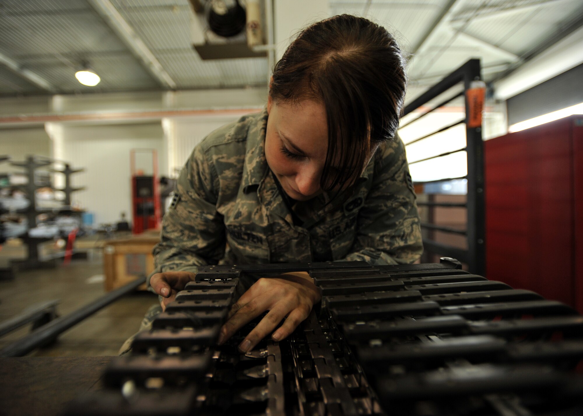Senior Airman Arendina Van Hulten, 51st Munitions Squadron weapons loader, repairs an A-10 Thunderbolt’s ammunition feeder at Osan Air Base, Republic of Korea, Sept. 25, 2013. Van Hulten specializes in inspecting, maintaining, and repairing parts of the A-10’s weapons system. (U.S. Air Force photo/Senior Airman Siuta B. Ika)