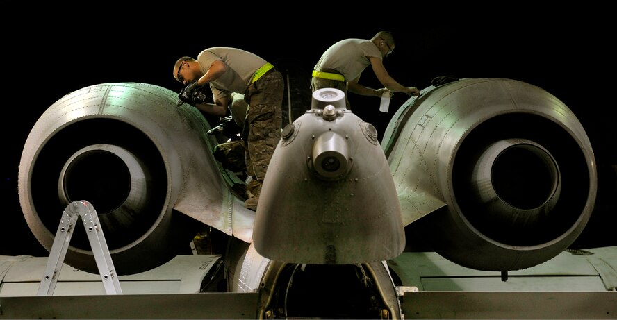 Crew chiefs assigned to the 455th Expeditionary Aircraft Maintenance Squadron replace aircraft panels on an A-10 Thunderbolt II aircraft during a phase inspection on Bagram Airfield, Afghanistan. The 455th EAMXS Airmen conducted 33 A-10 phase inspections during their six month deployment here. The A-10's and maintainers are deployed from Moody Air Force Base, Ga. (U.S. Air Force photo/ Staff Sgt. Stephenie Wade)