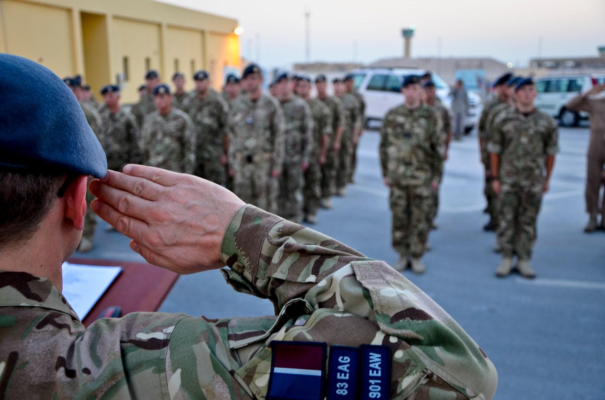 Group Capt. Domonic Stamp salutes his troops during the Battle of Britain Day parade ceremony at the 379th Air Expeditionary Wing in Southwest Asia, Sept. 20, 2013. The RAF holds this day special as it was the day the Luftwaffe embarked on their largest bombing attack yet, forcing the engagement of the entire RAF Fighter Command in defense of London and the South East, which resulted in a decisive victory in favor of Britain and marked a turning point in the war. Stamp is the 83 Expeditionary Air Group’s deputy air component commander. (U.S. Air Force photo/Staff Sgt. Benjamin W. Stratton) 